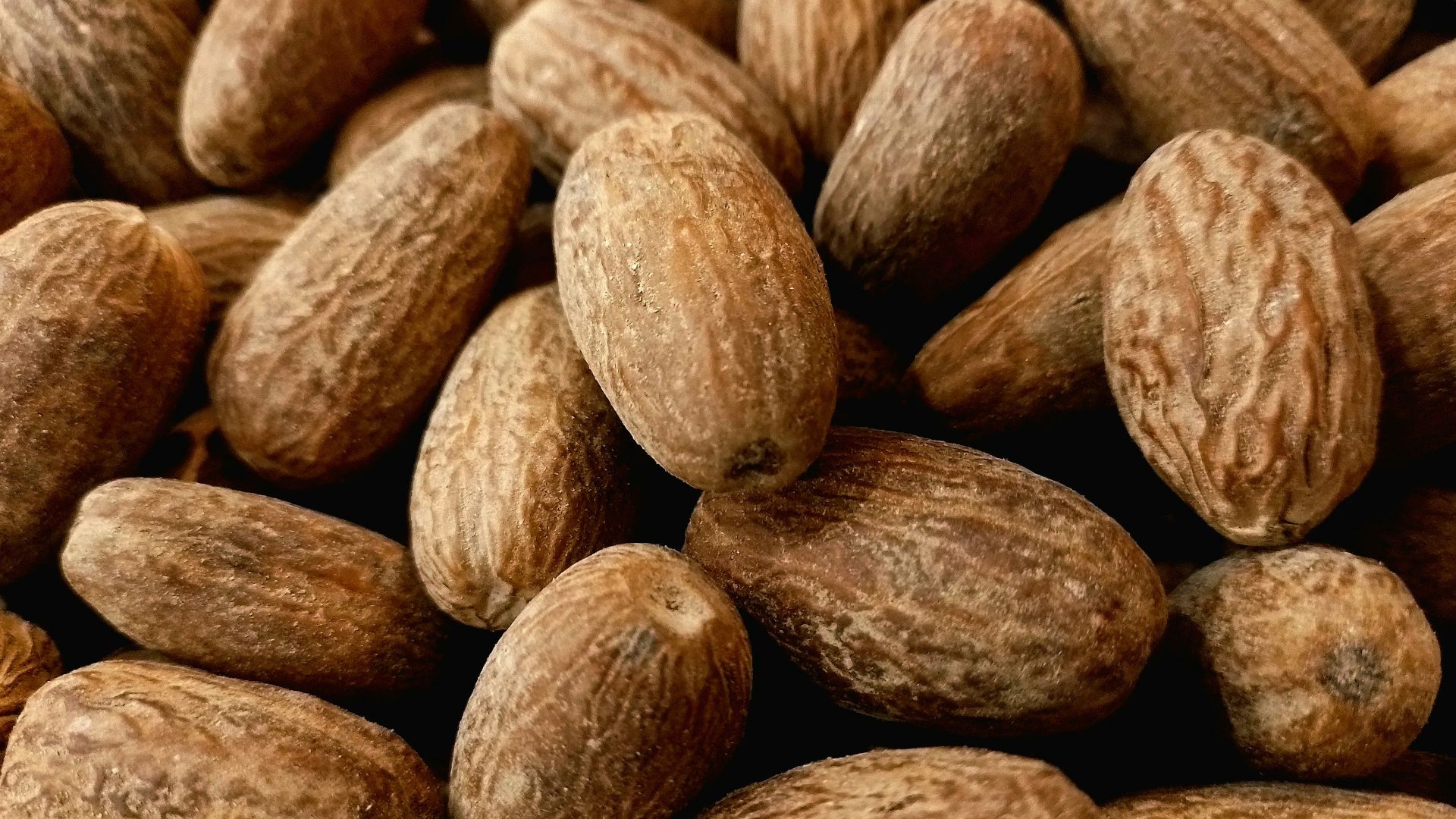 a pile of almonds sitting next to each other