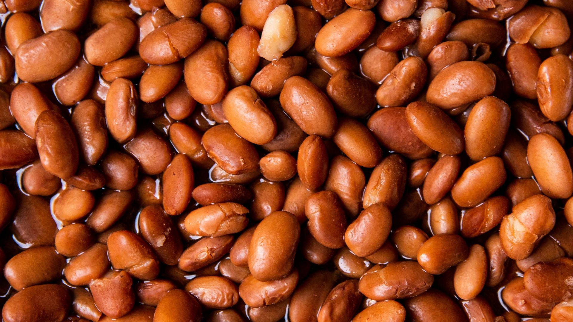 brown coffee beans on brown wooden surface