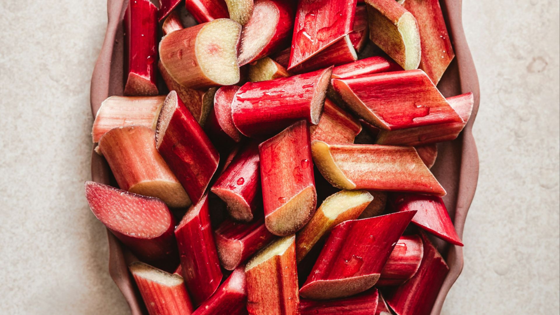 a bowl filled with sliced up rhubaras on top of a table
