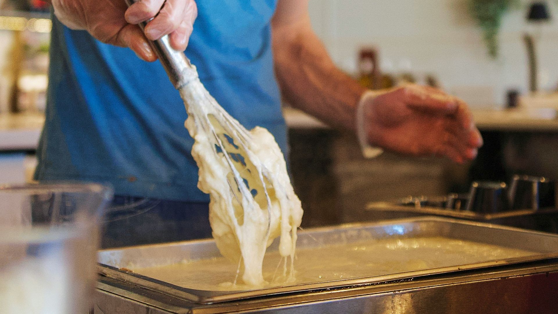 A man cooks in a restaurant kitchen.