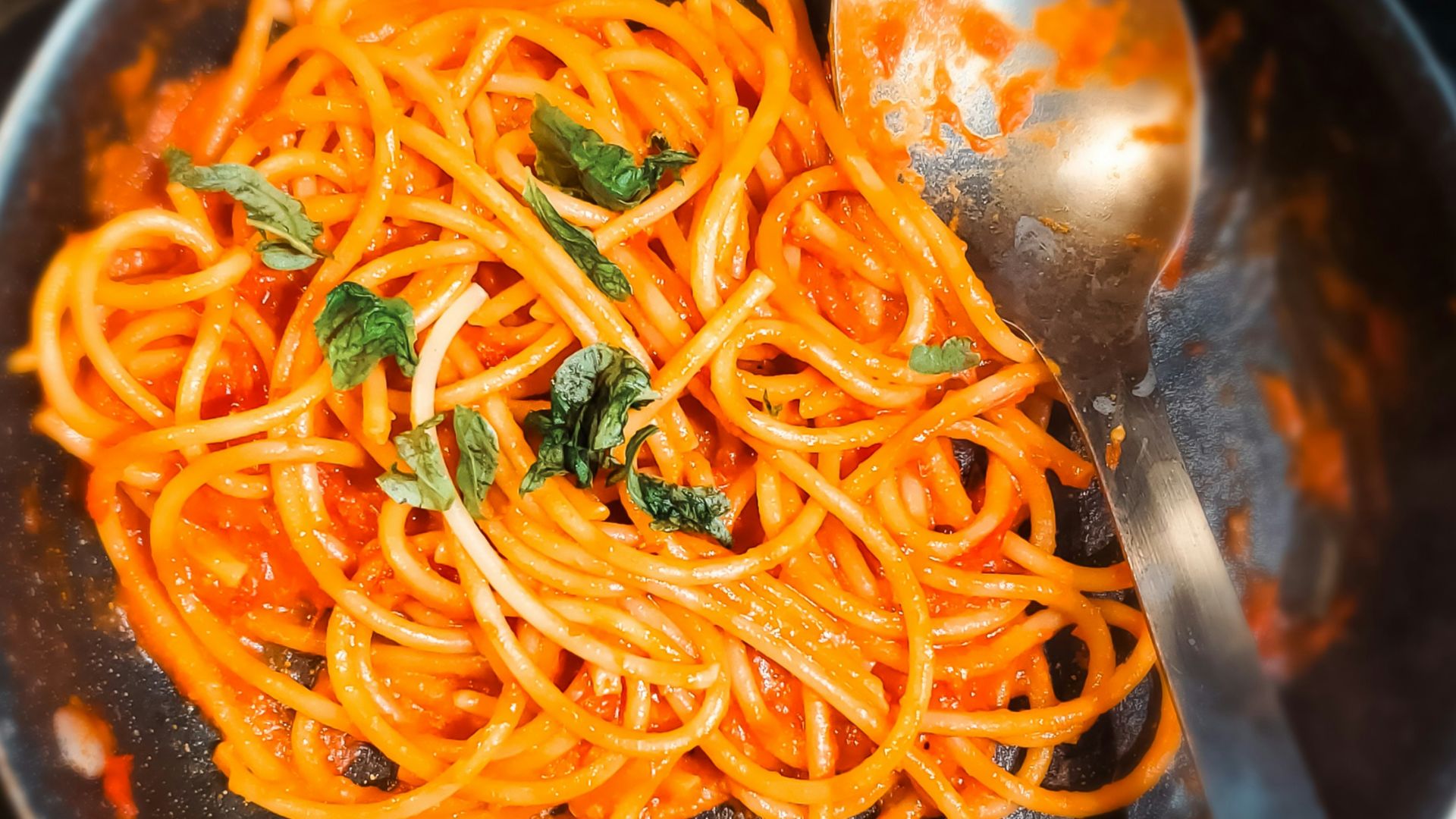 Pasta in tomato sauce with fresh basil.