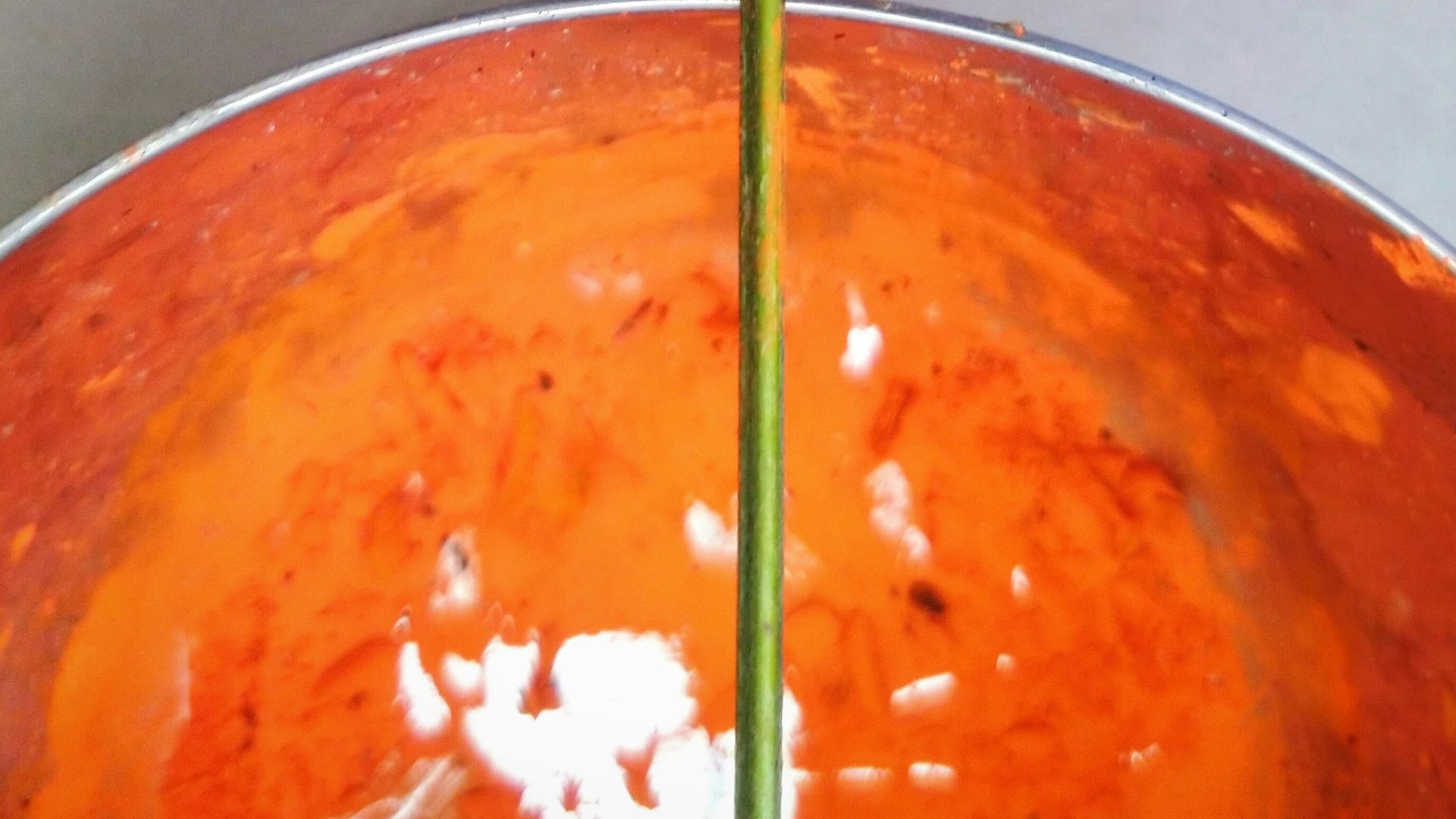 green plastic straw in orange plastic cup