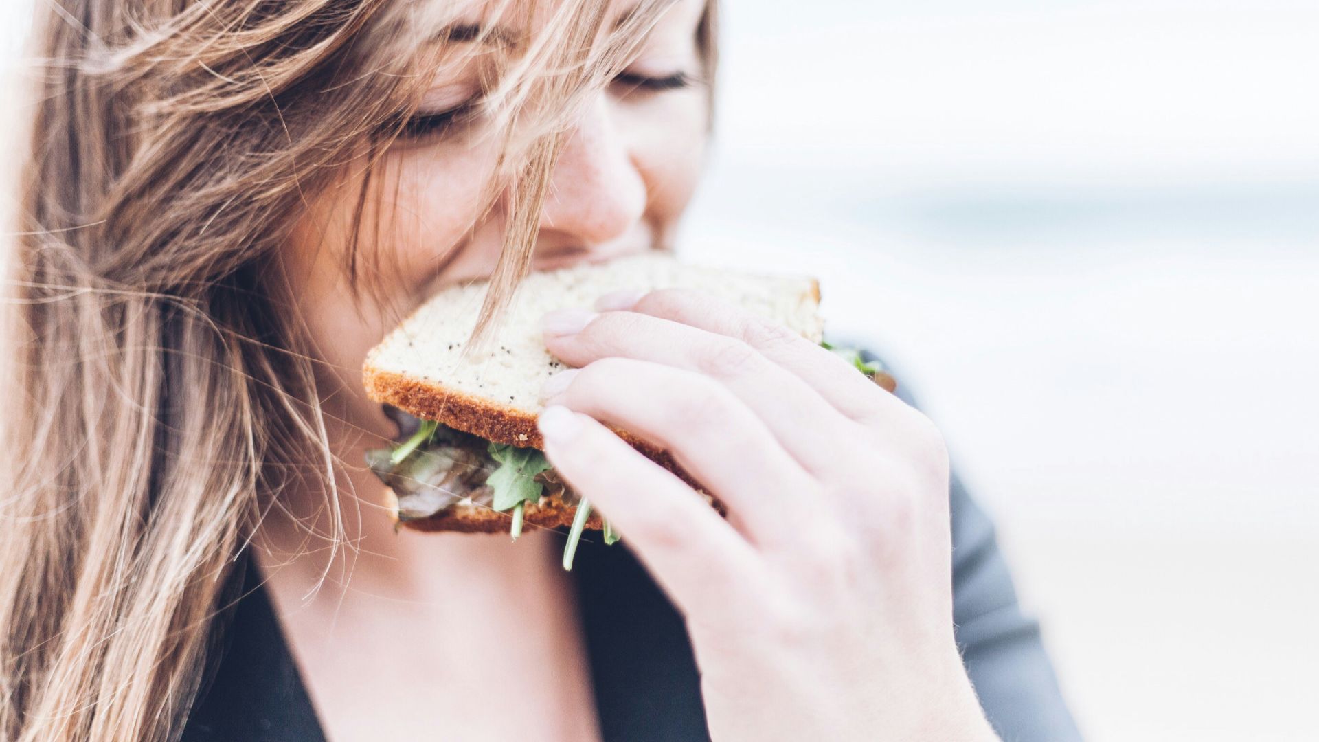 woman eating sandwich