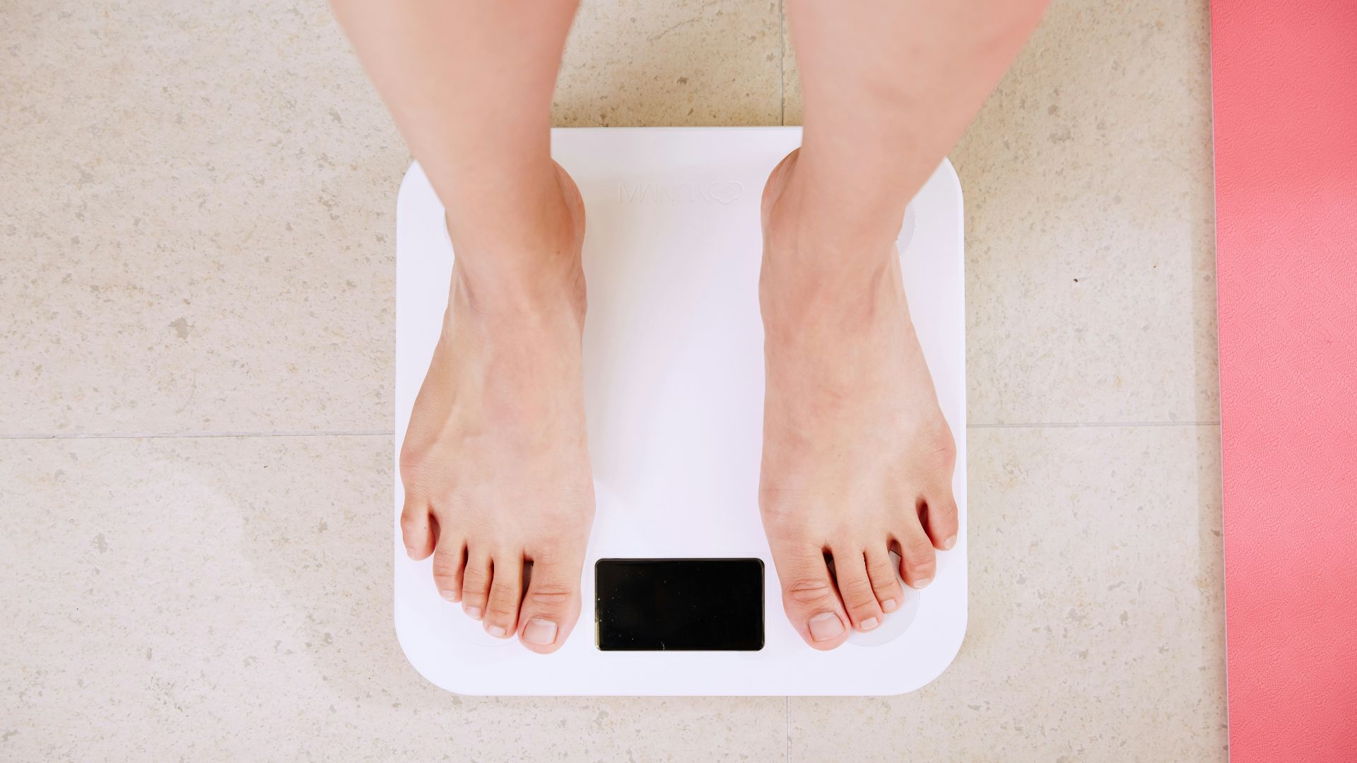 person standing on white digital bathroom scale