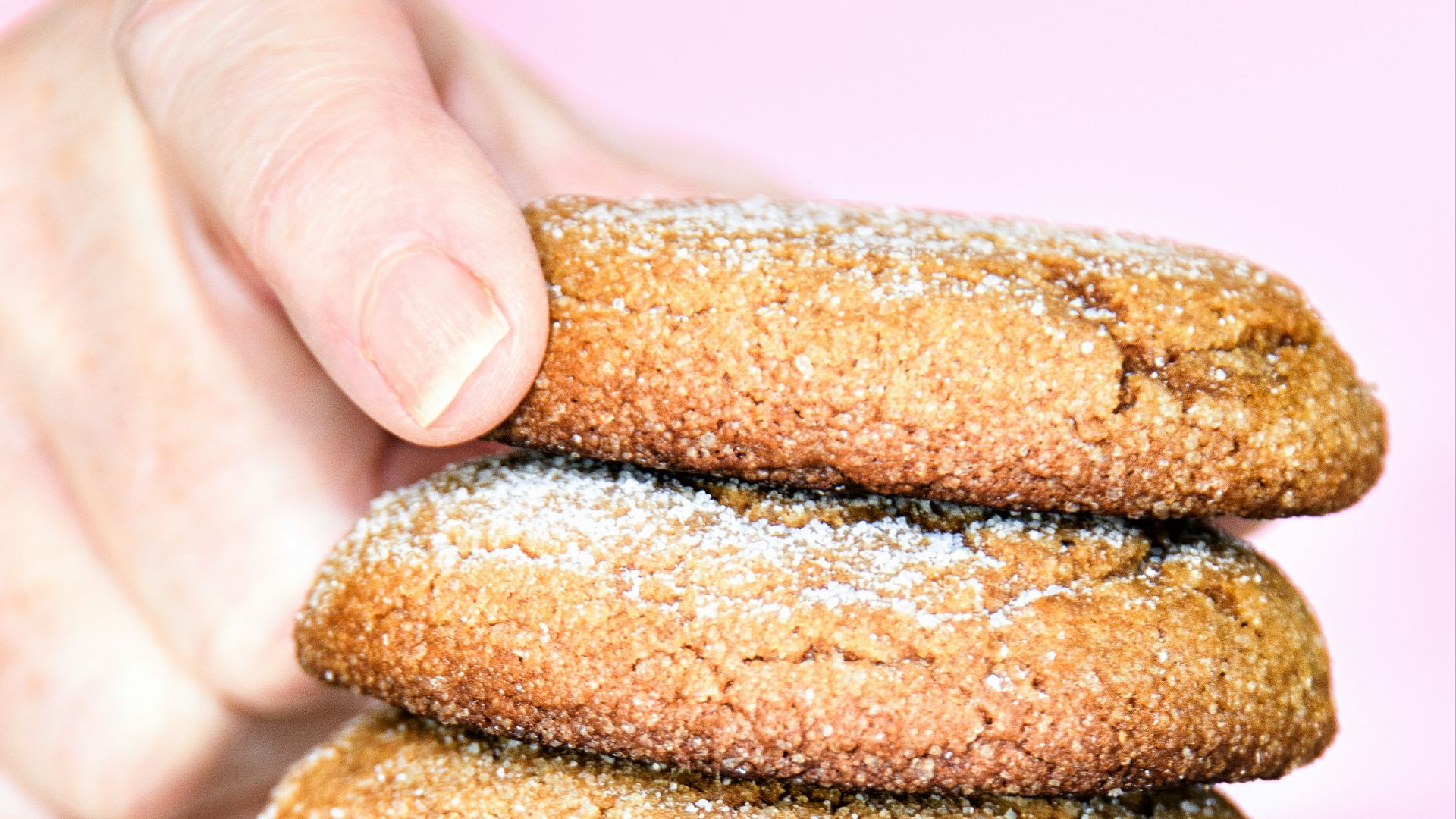 a stack of cookies with powdered sugar on top