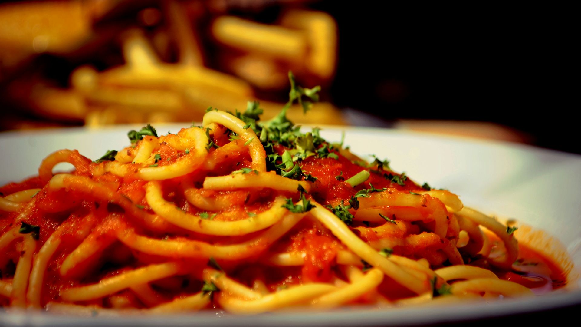a plate of spaghetti with tomato sauce and parsley