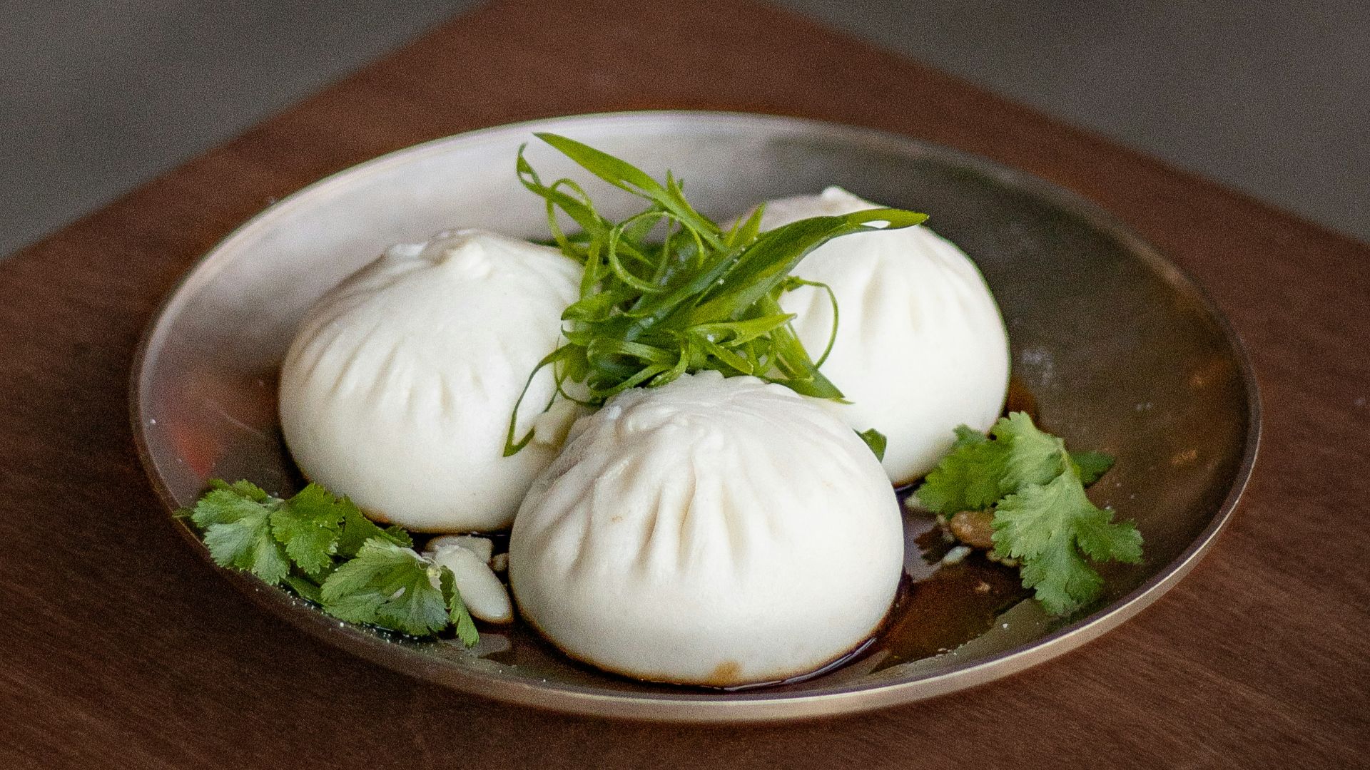a plate of dumplings on a wooden table