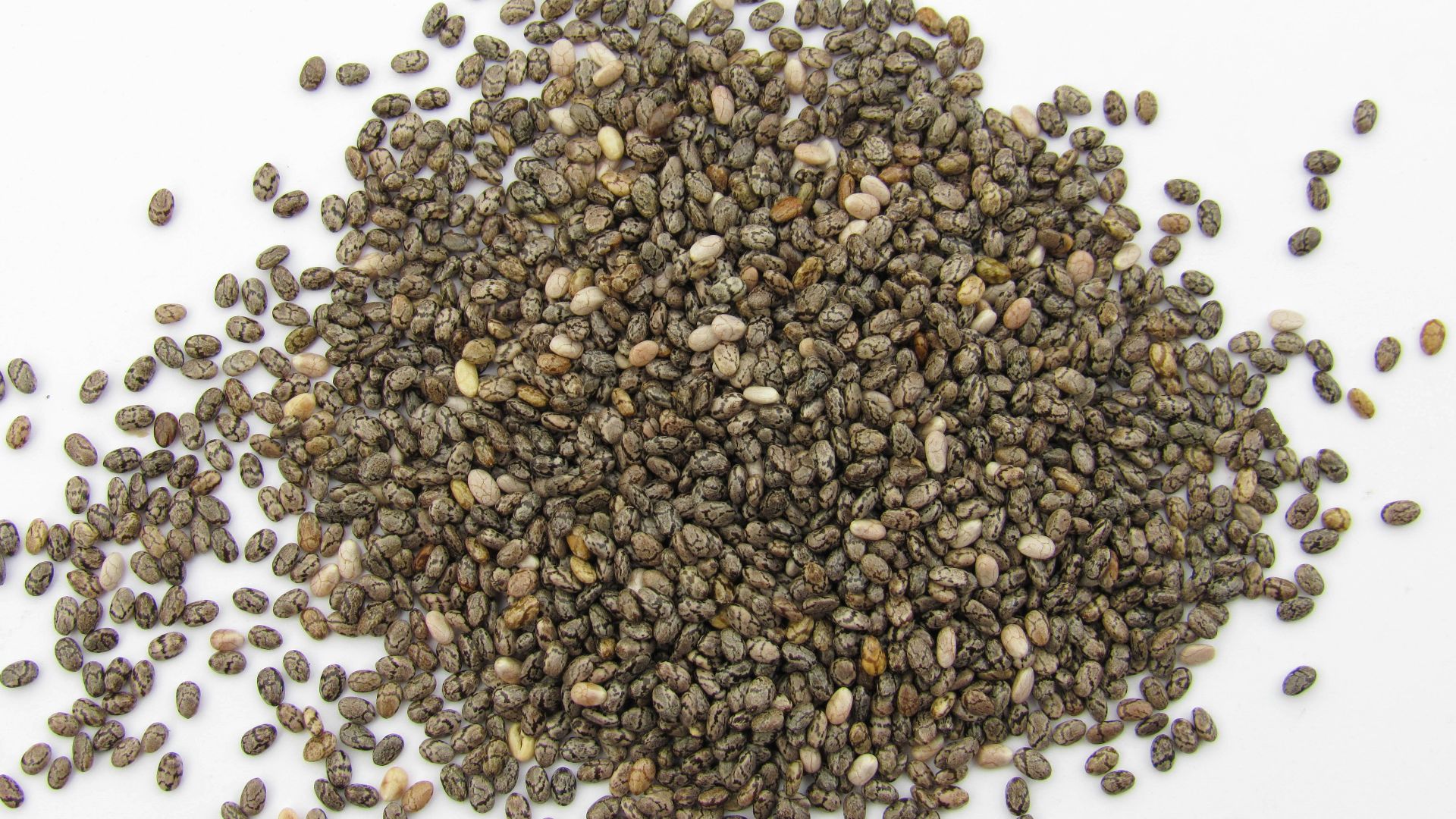a pile of seeds on a white surface
