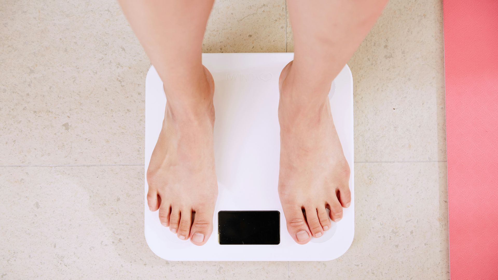 person standing on white digital bathroom scale