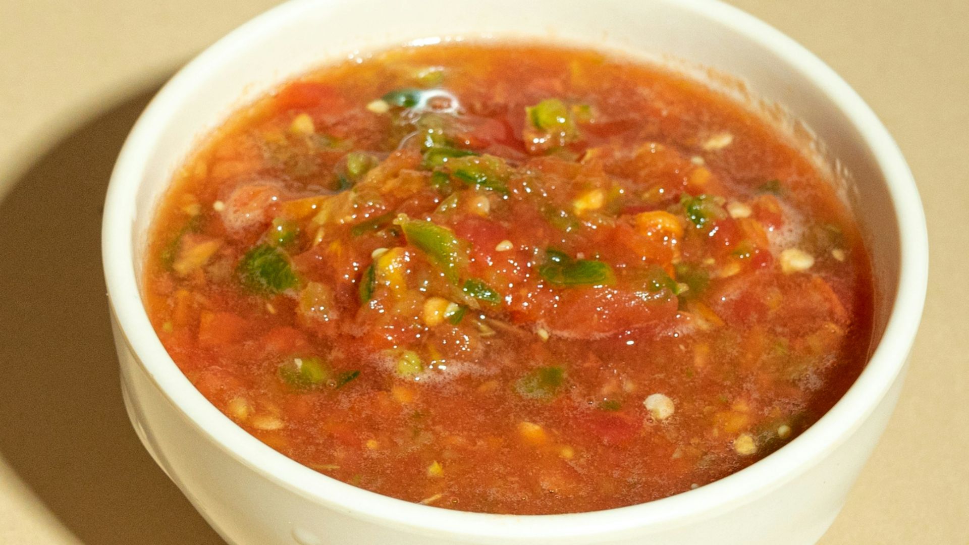 A bowl of soup is sitting on a table