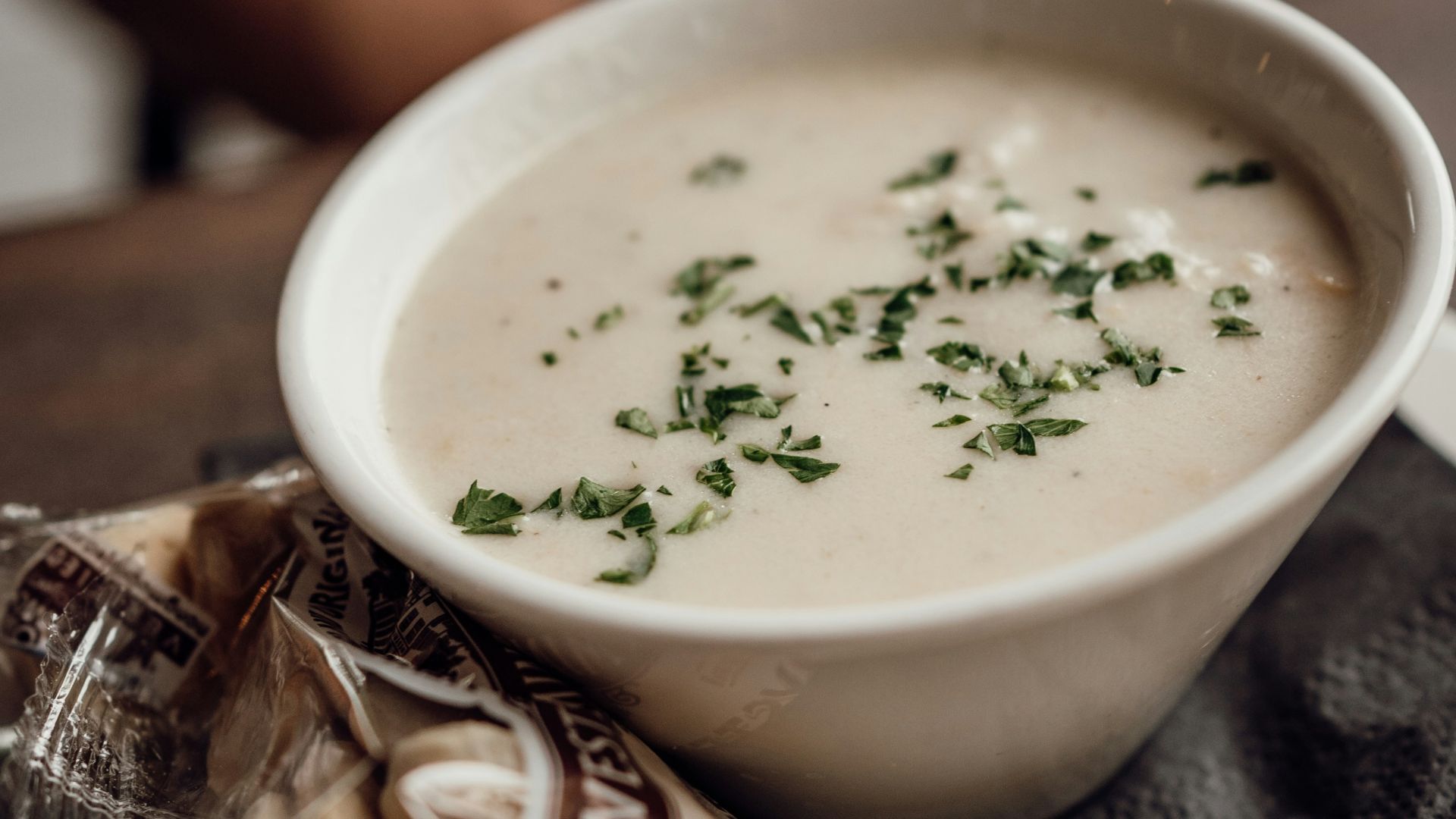 A bowl of soup sitting on top of a white plate