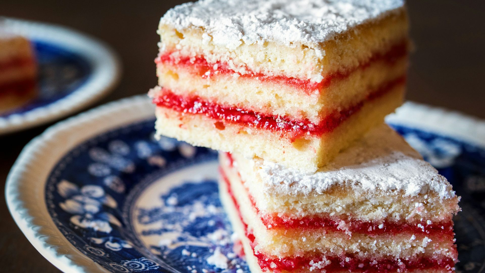 three pieces of cake on a blue and white plate