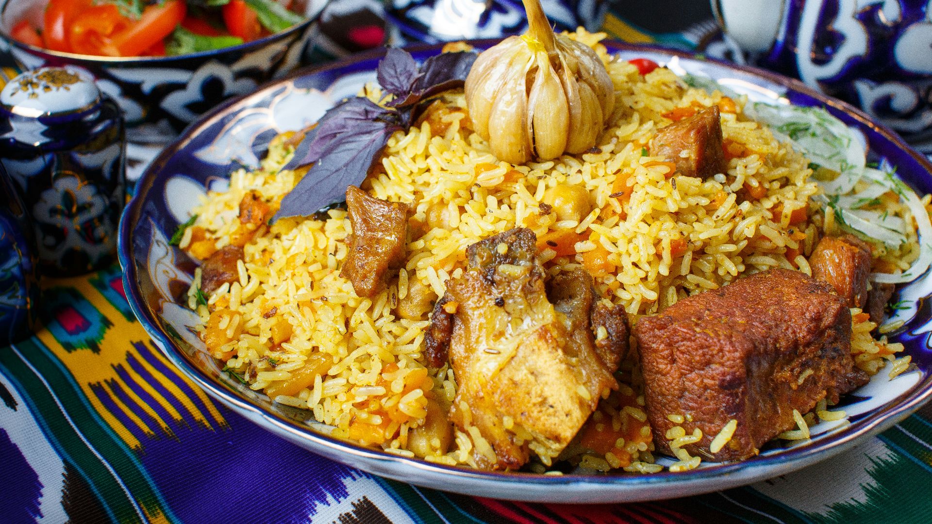 a plate of rice with meat and vegetables