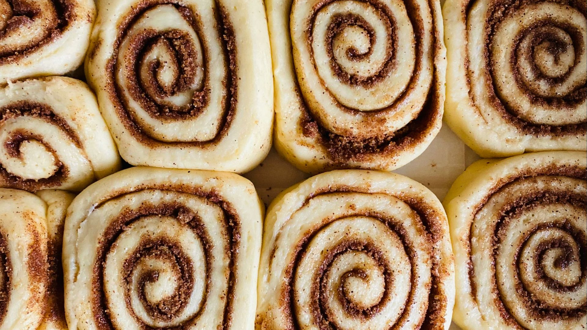 a close up of a plate of cinnamon rolls