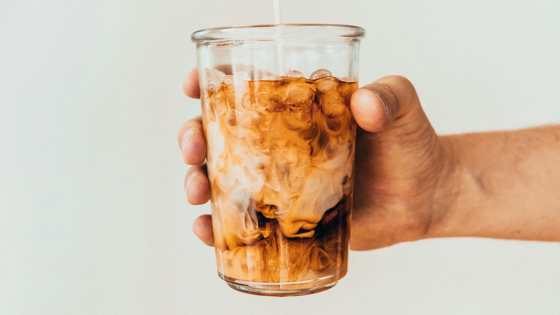 clear drinking glass with brown liquid