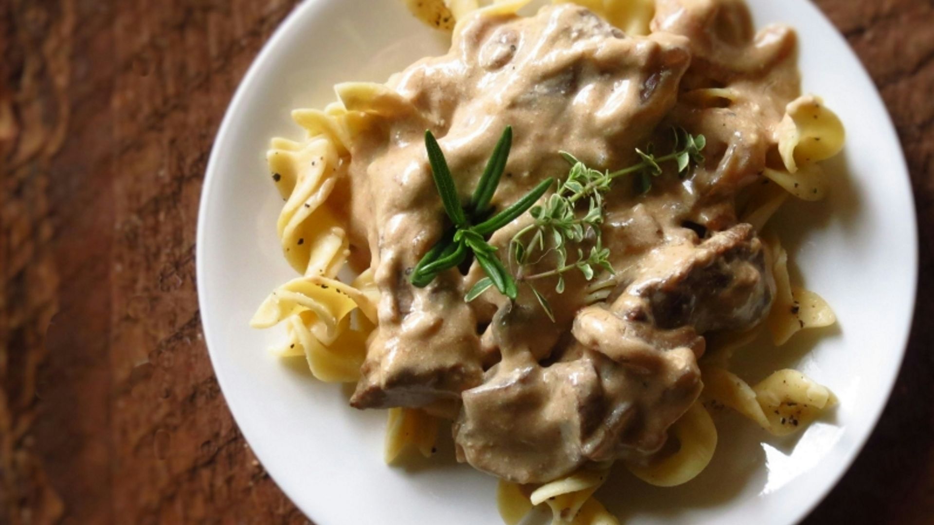 a white plate topped with pasta covered in sauce