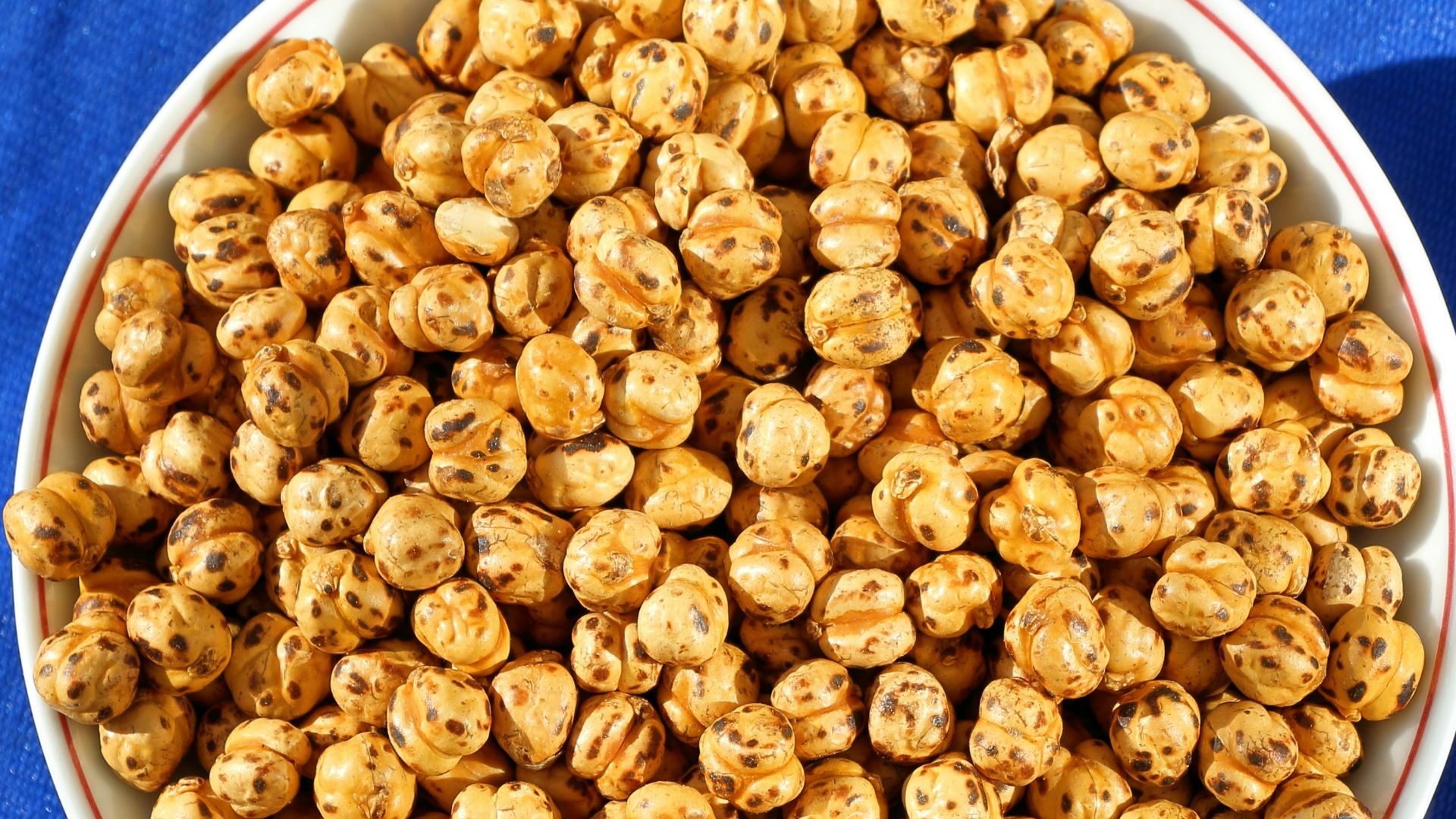 a bowl of popcorn on a blue cloth