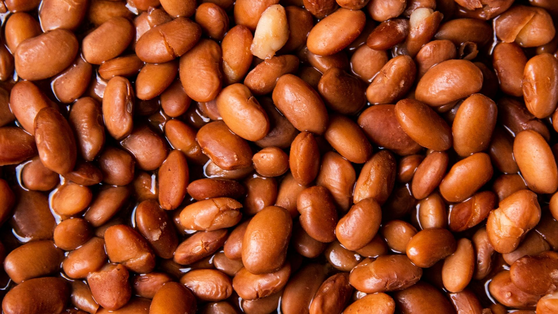 brown coffee beans on brown wooden surface