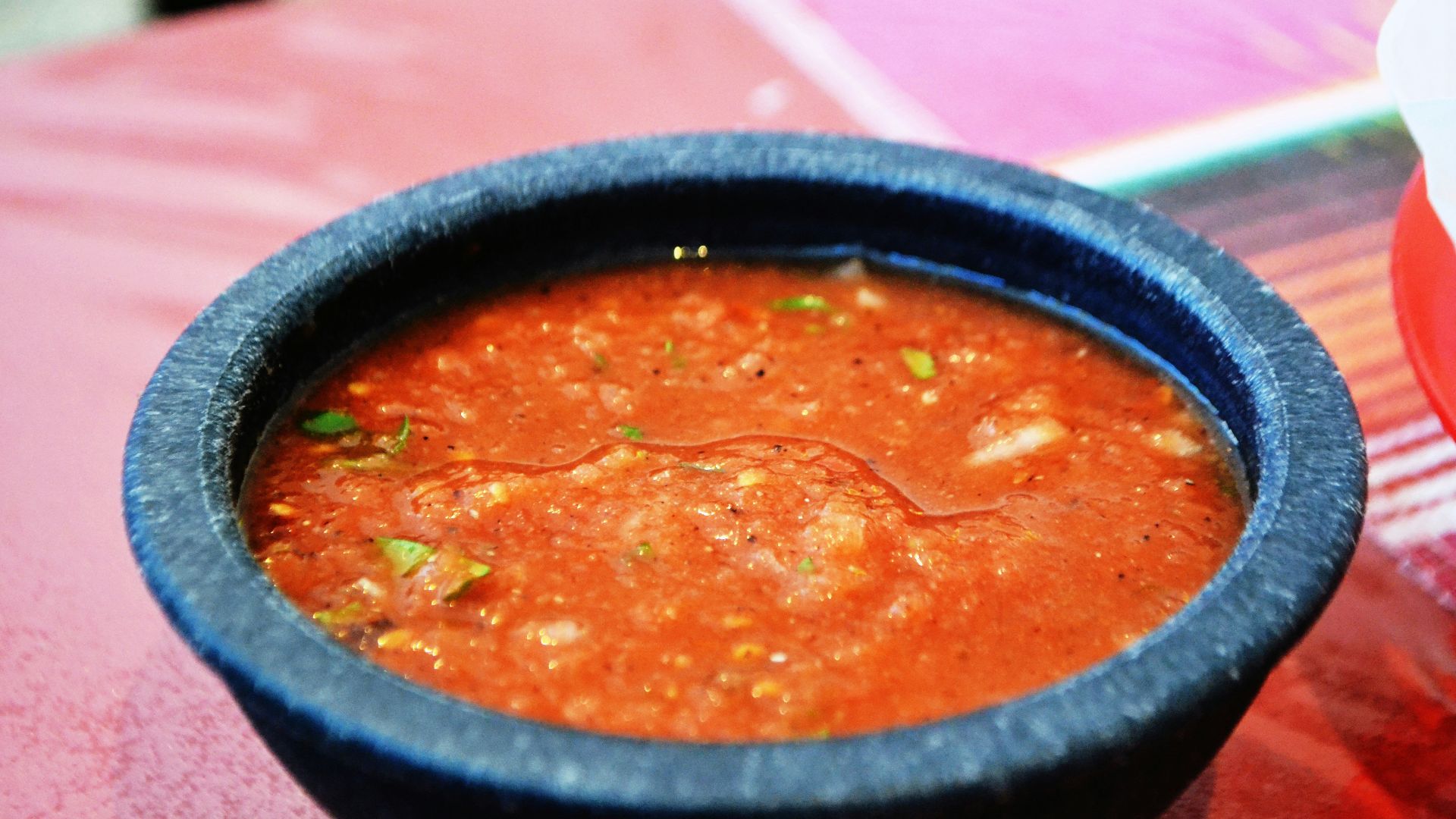 a bowl of soup sitting on top of a table