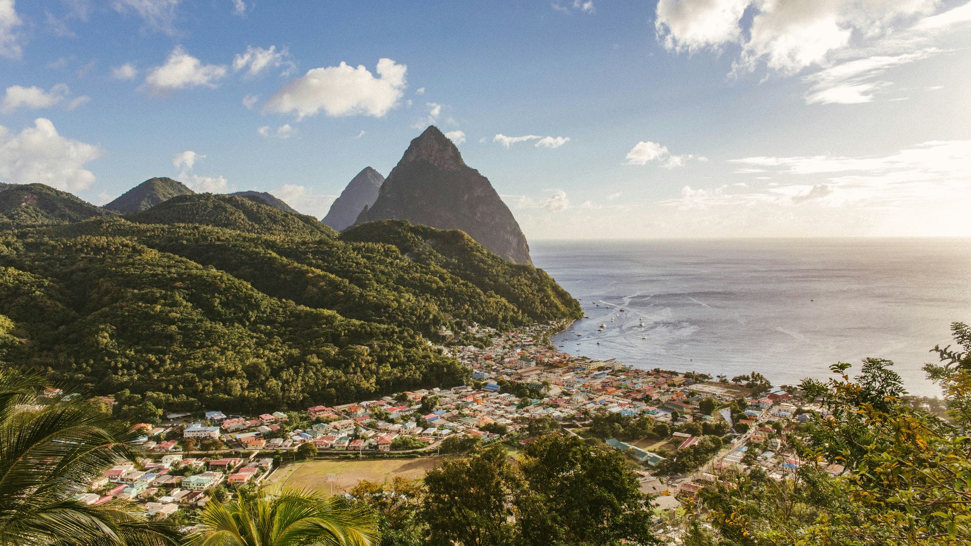 green mountain near body of water during daytime