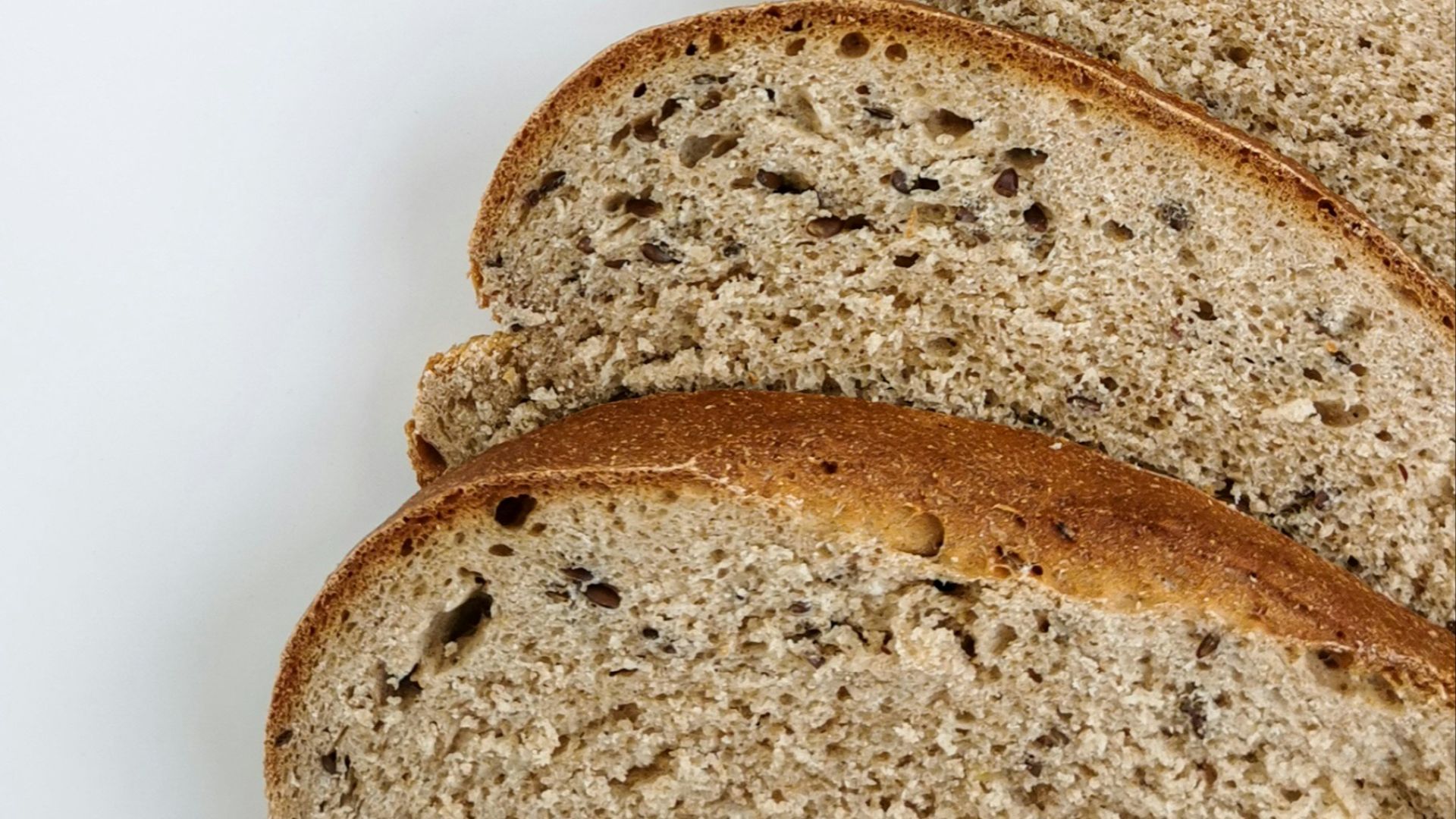 a loaf of whole wheat bread on a white surface