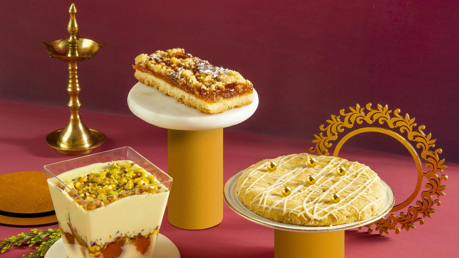 A variety of desserts on plates on a pink surface