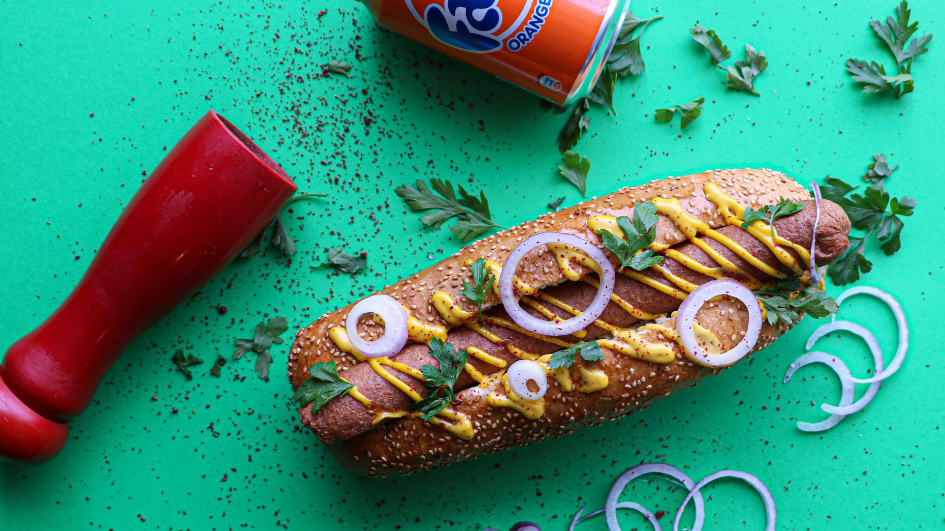 a sandwich with onion rings, mustard, and ketchup