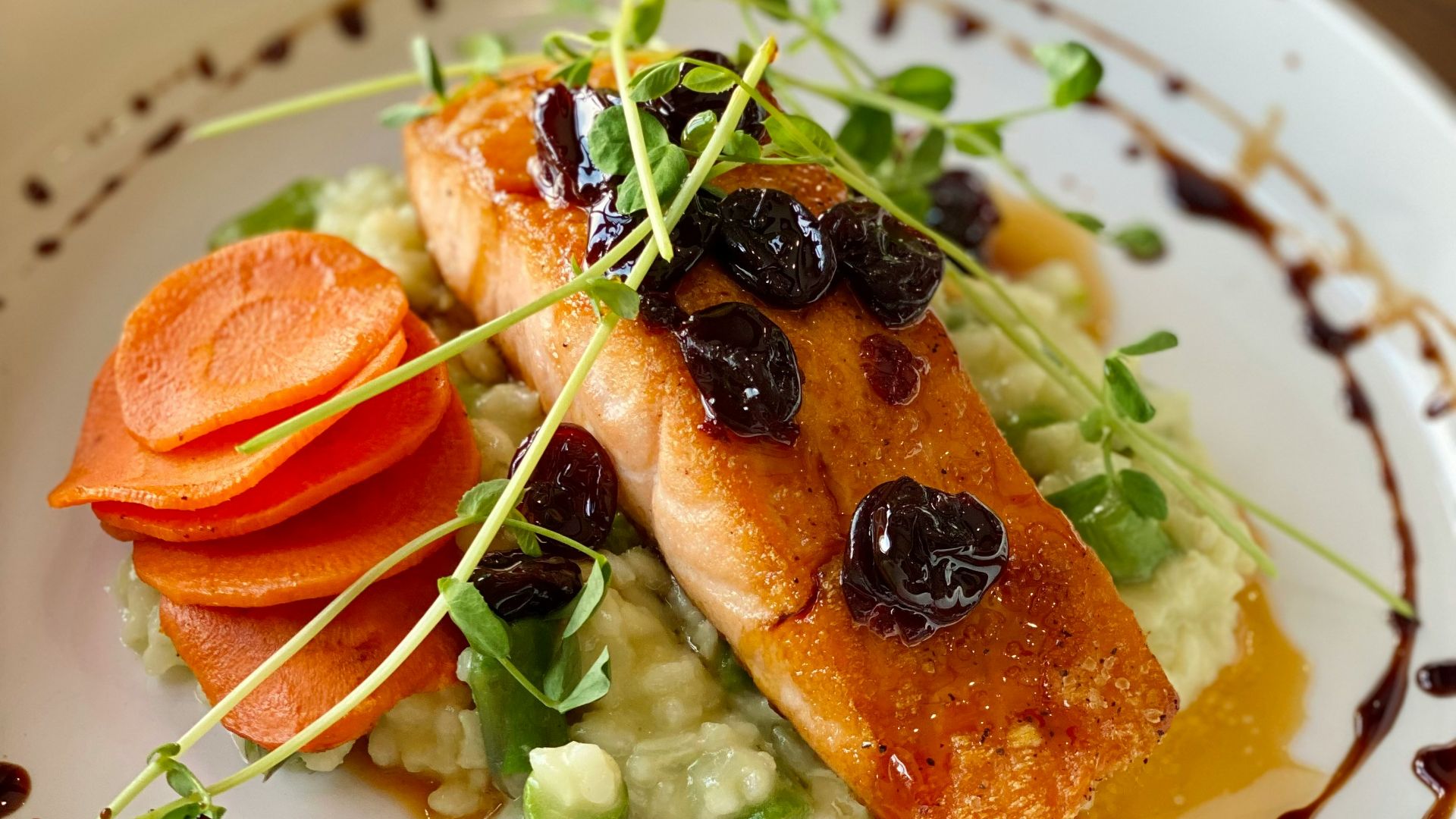 a white plate topped with fish and veggies