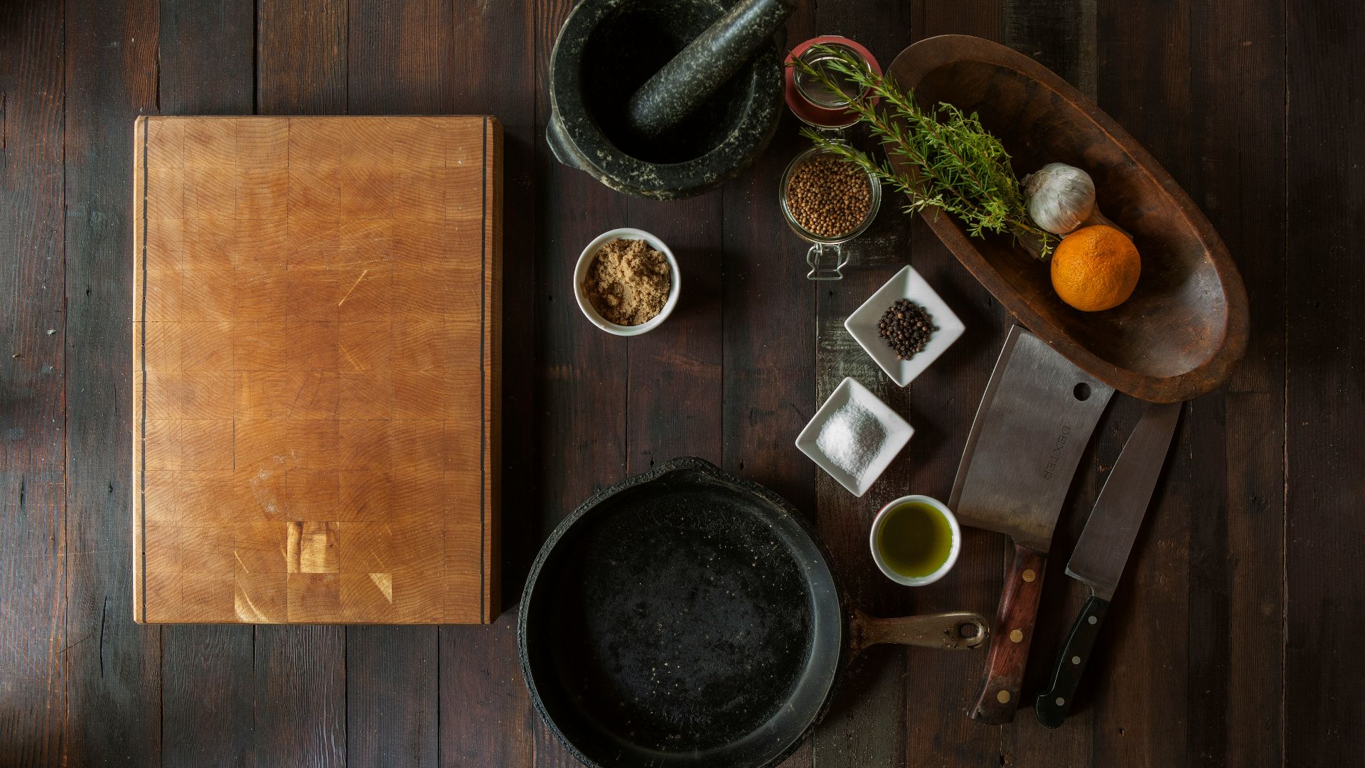 black mortar and pestle beside brown box in top view photography