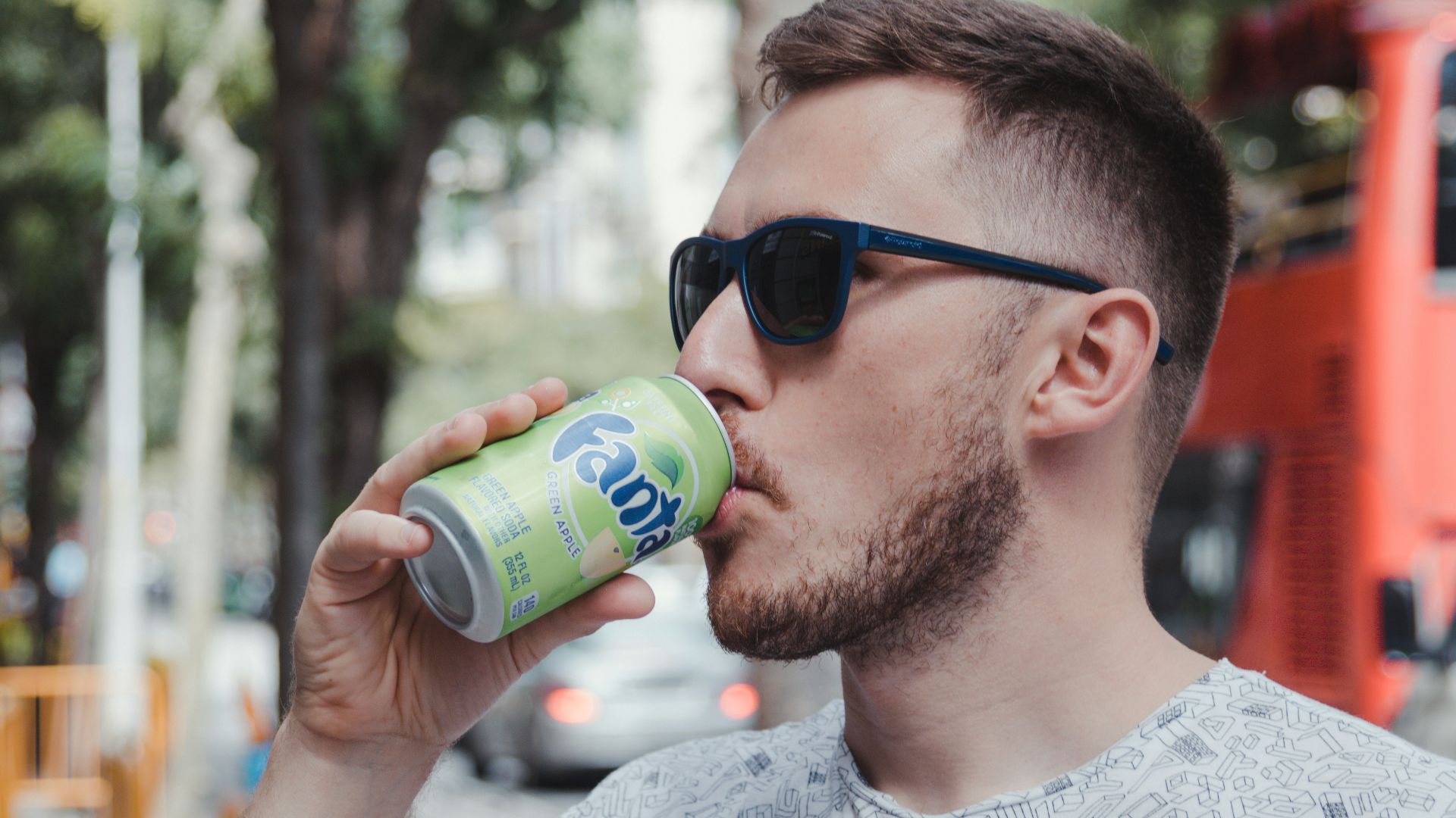 man drinking fanta soda can