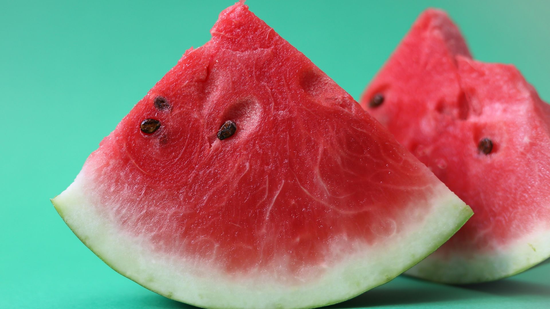 sliced watermelon on green surface