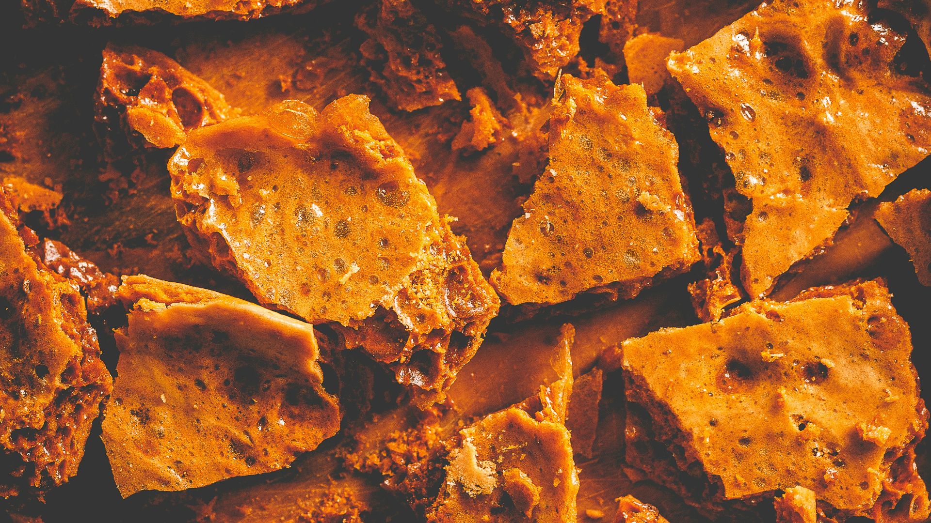 a pile of tortilla chips sitting on top of a wooden cutting board
