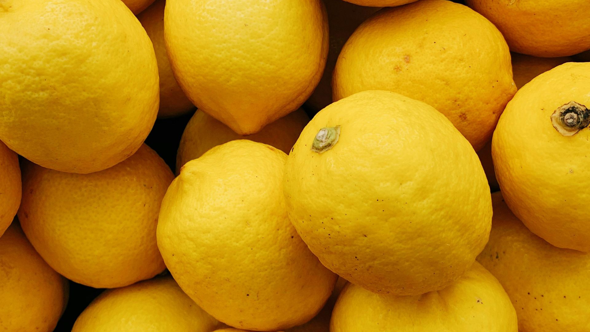 yellow citrus fruits on black surface
