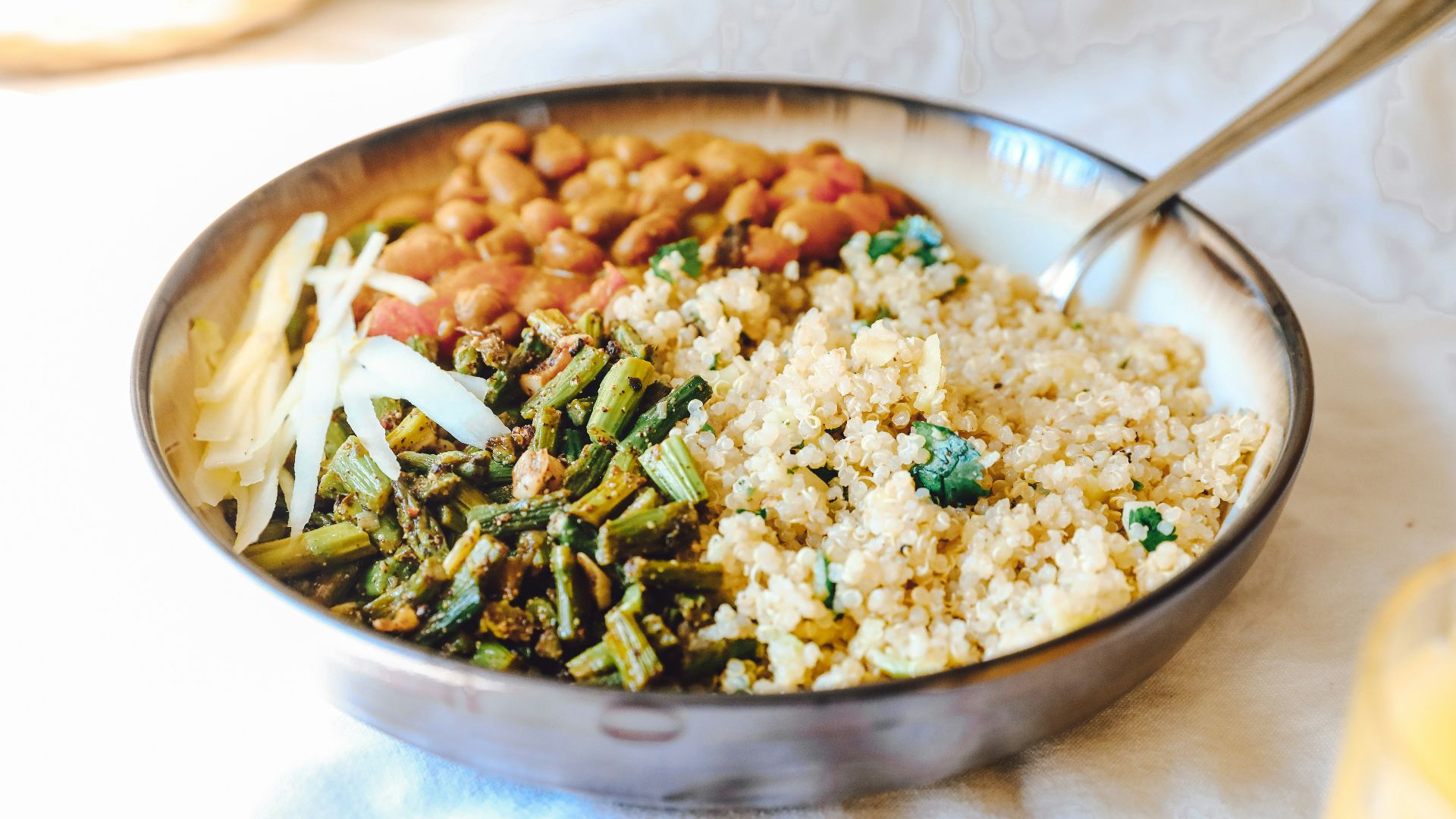cooked rice with green peas and carrots on stainless steel bowl
