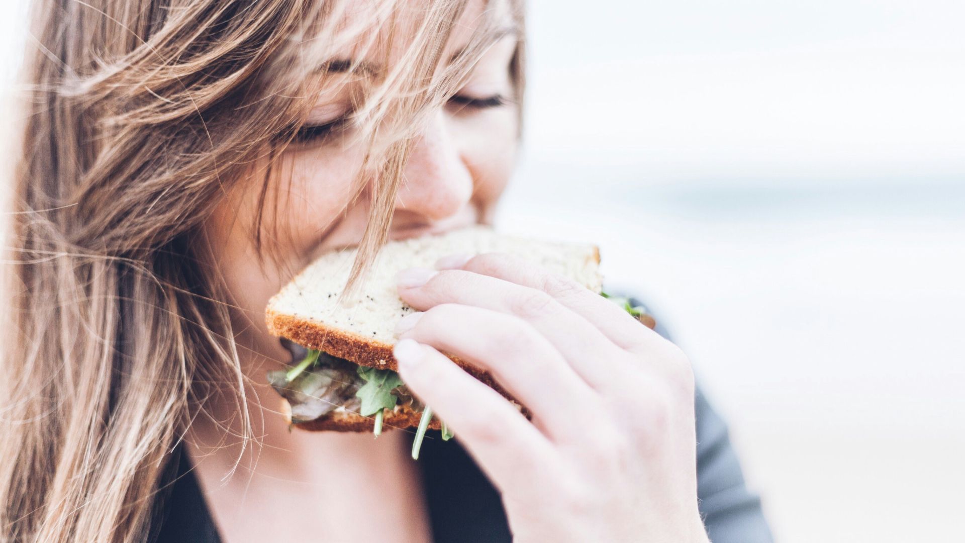 woman eating sandwich