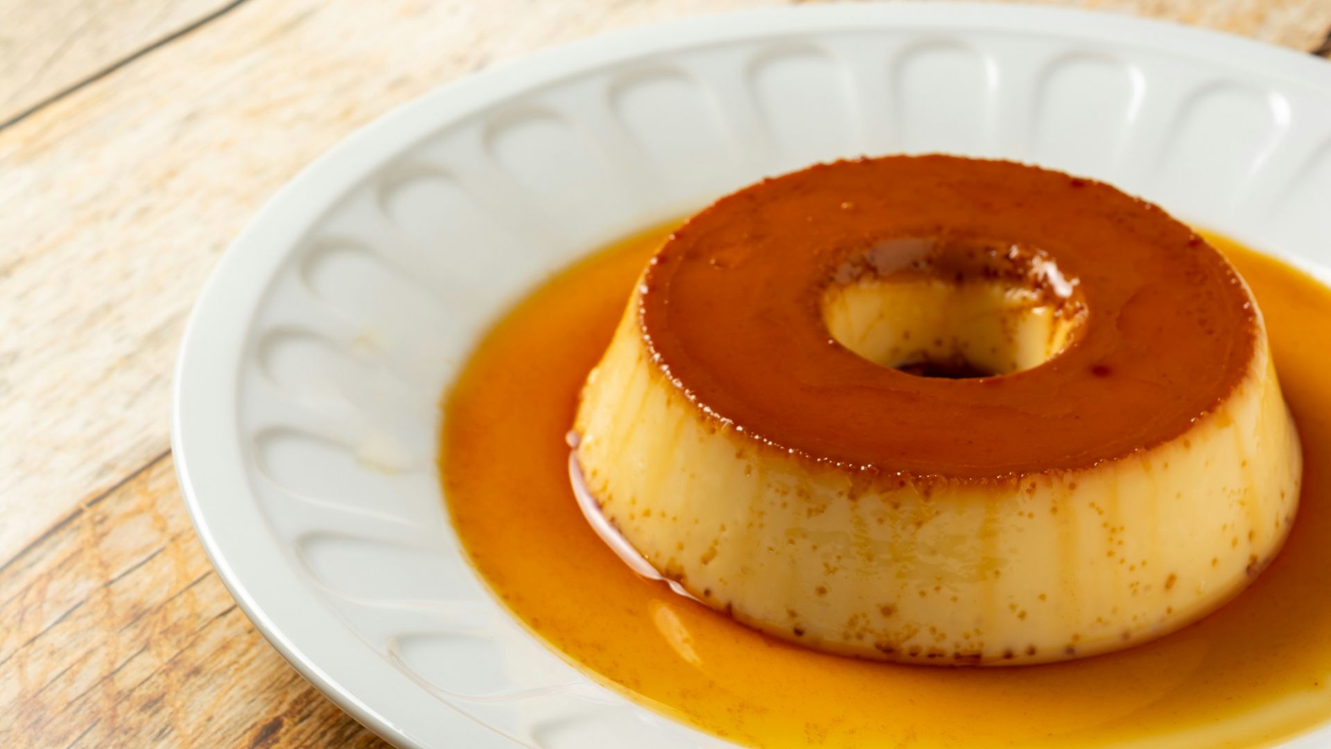 a small dessert on a white plate on a wooden table