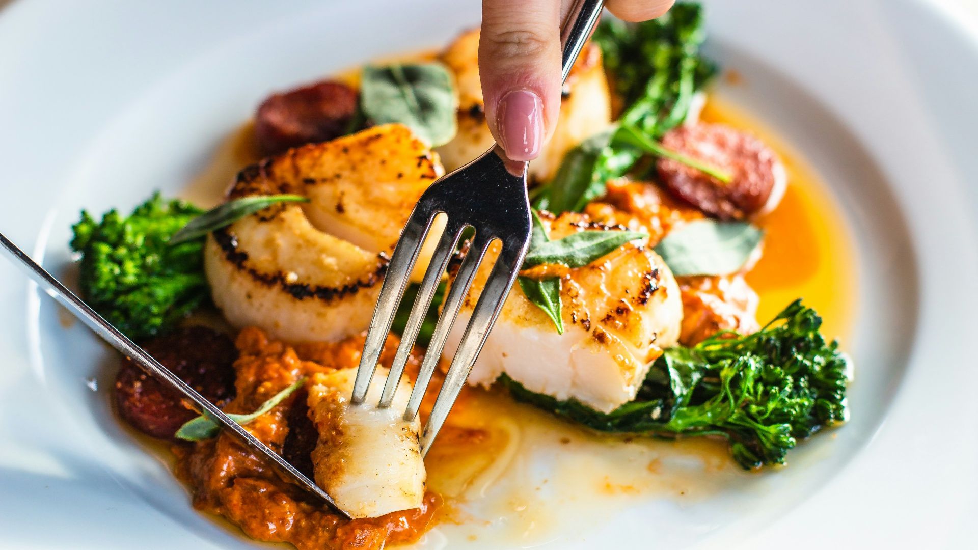 stainless steel fork on white ceramic plate