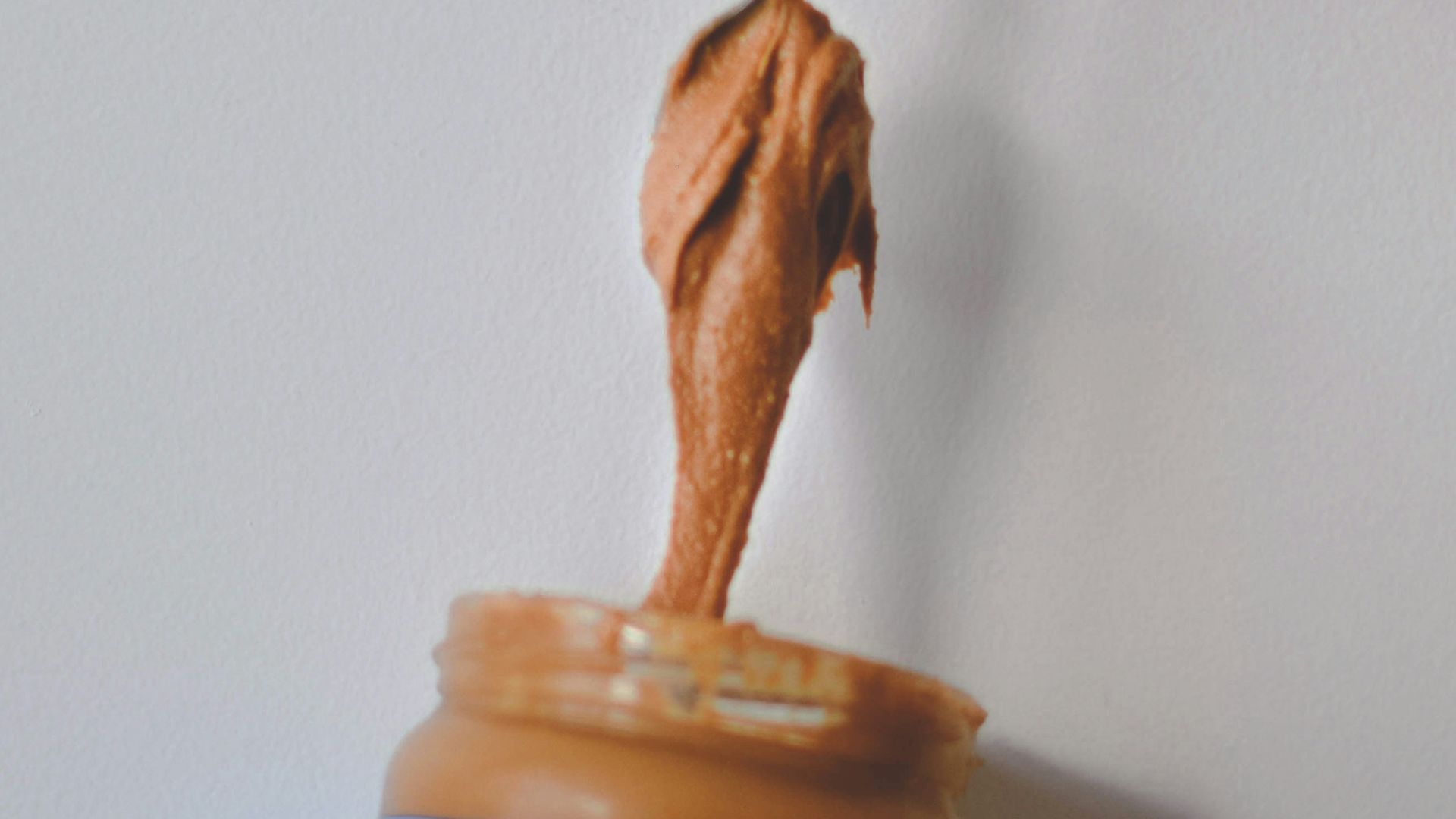 person holding blue and white plastic bottle