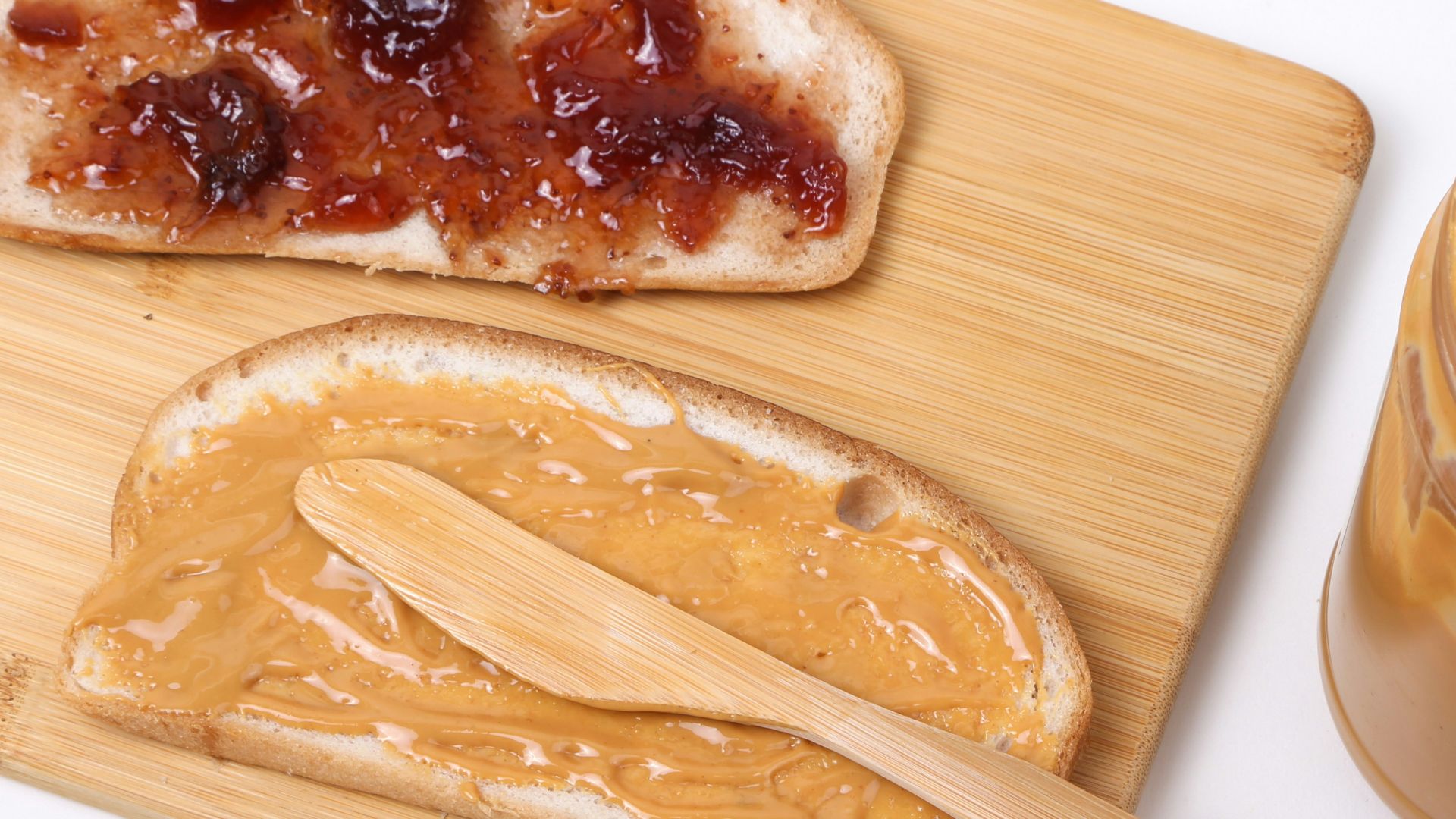 a wooden spoon next to a bowl of food