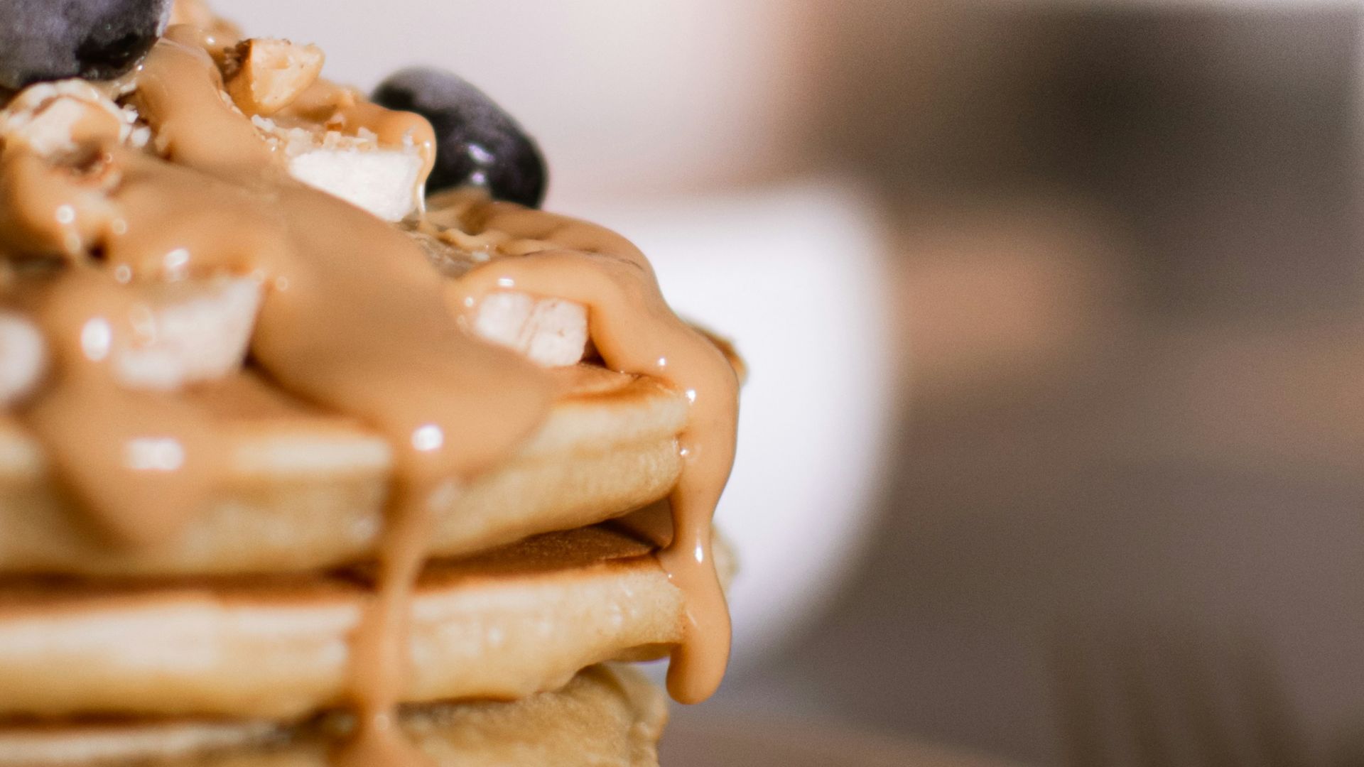 waffle with black berries on white ceramic plate
