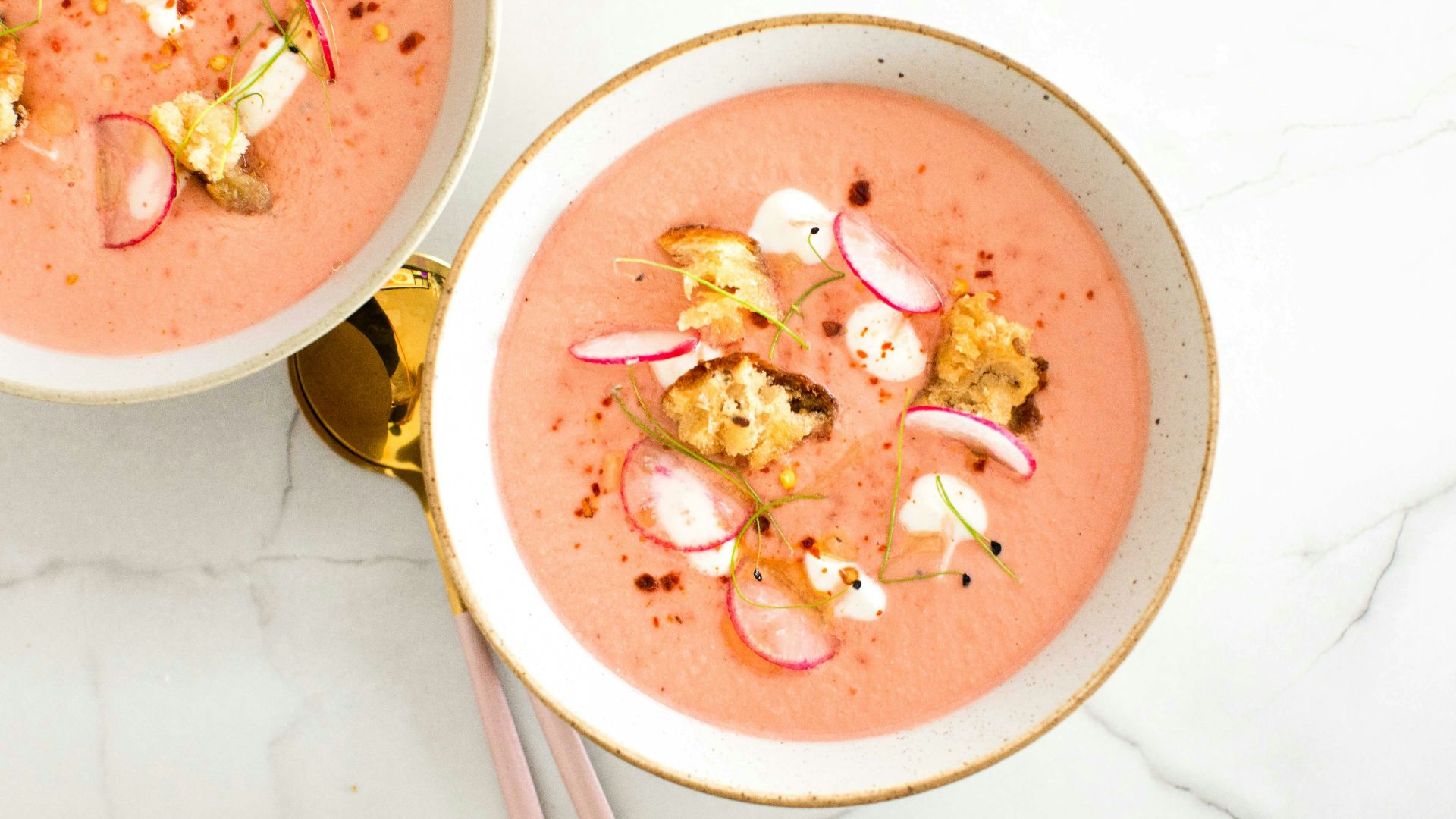 a bowl of soup with chopsticks