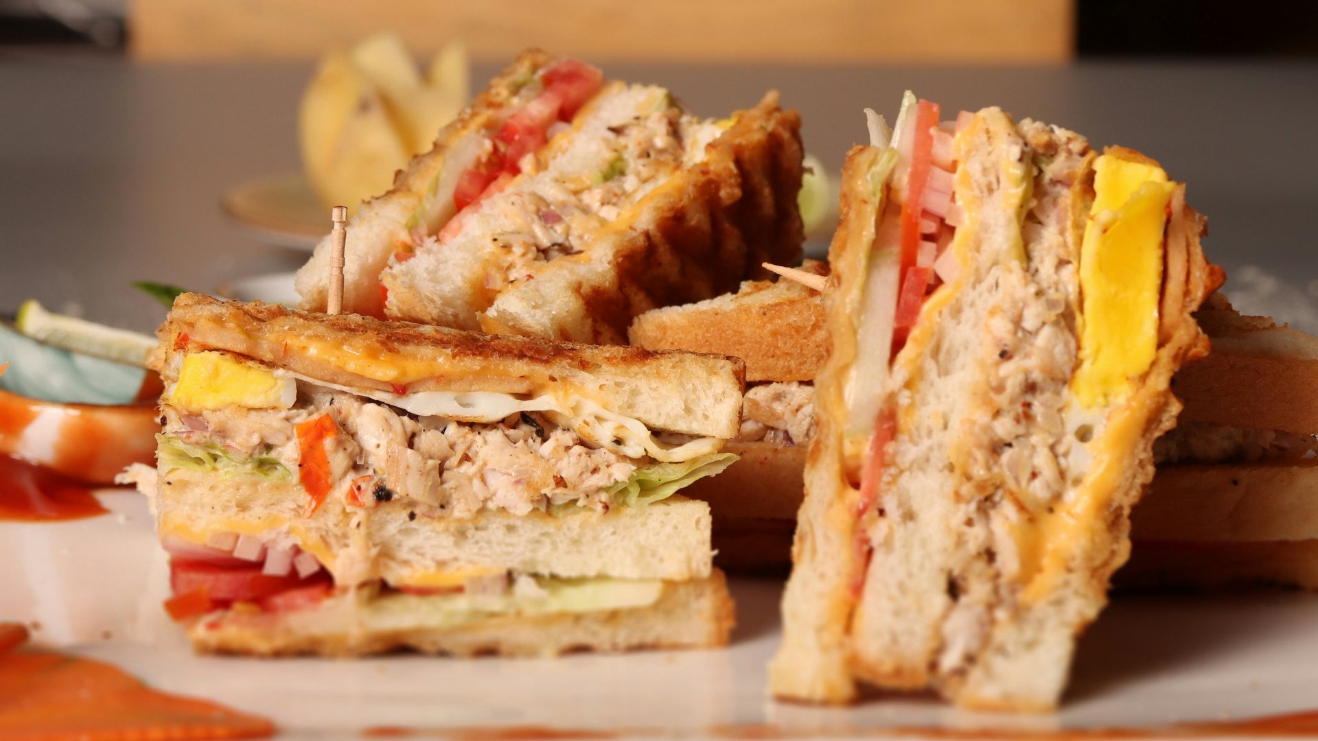 a sandwich cut in half sitting on a plate