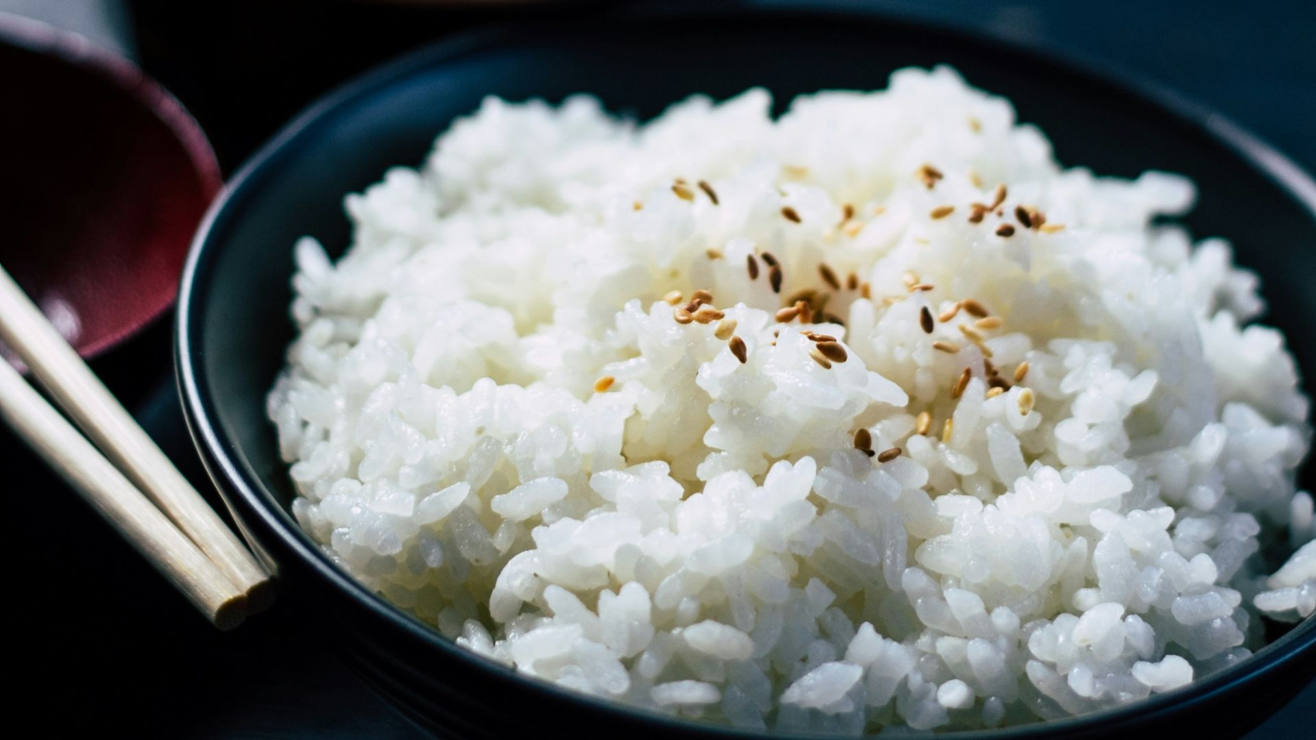 rice with sesame in black bowl