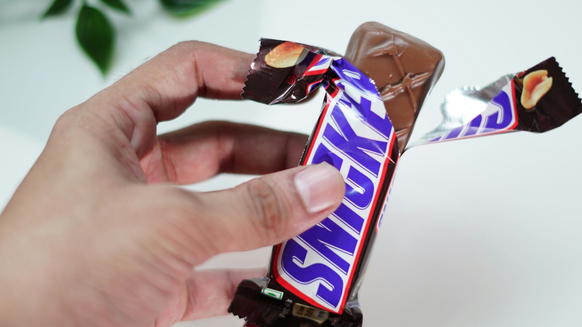 a hand holding a pack of cigarettes