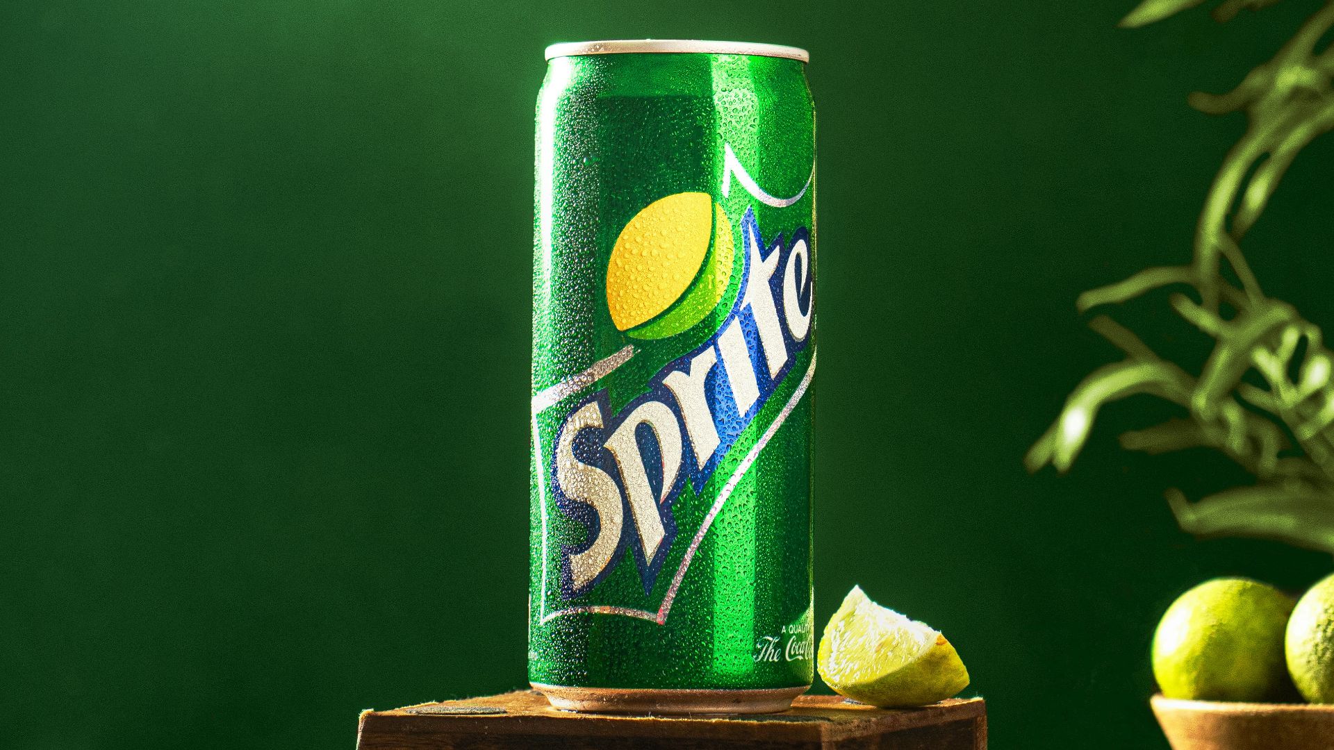 a can of sprite on a wooden stand with limes