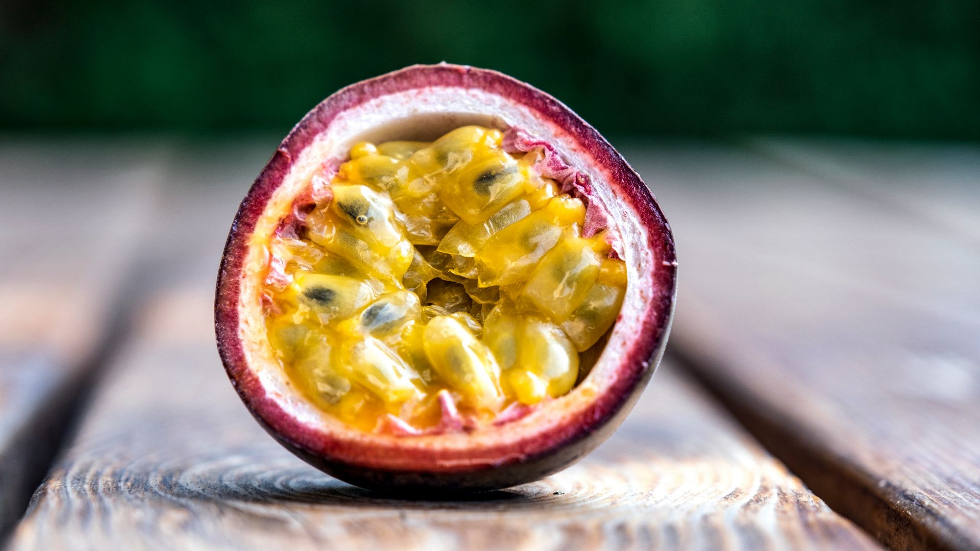 red and yellow round fruit on brown wooden table