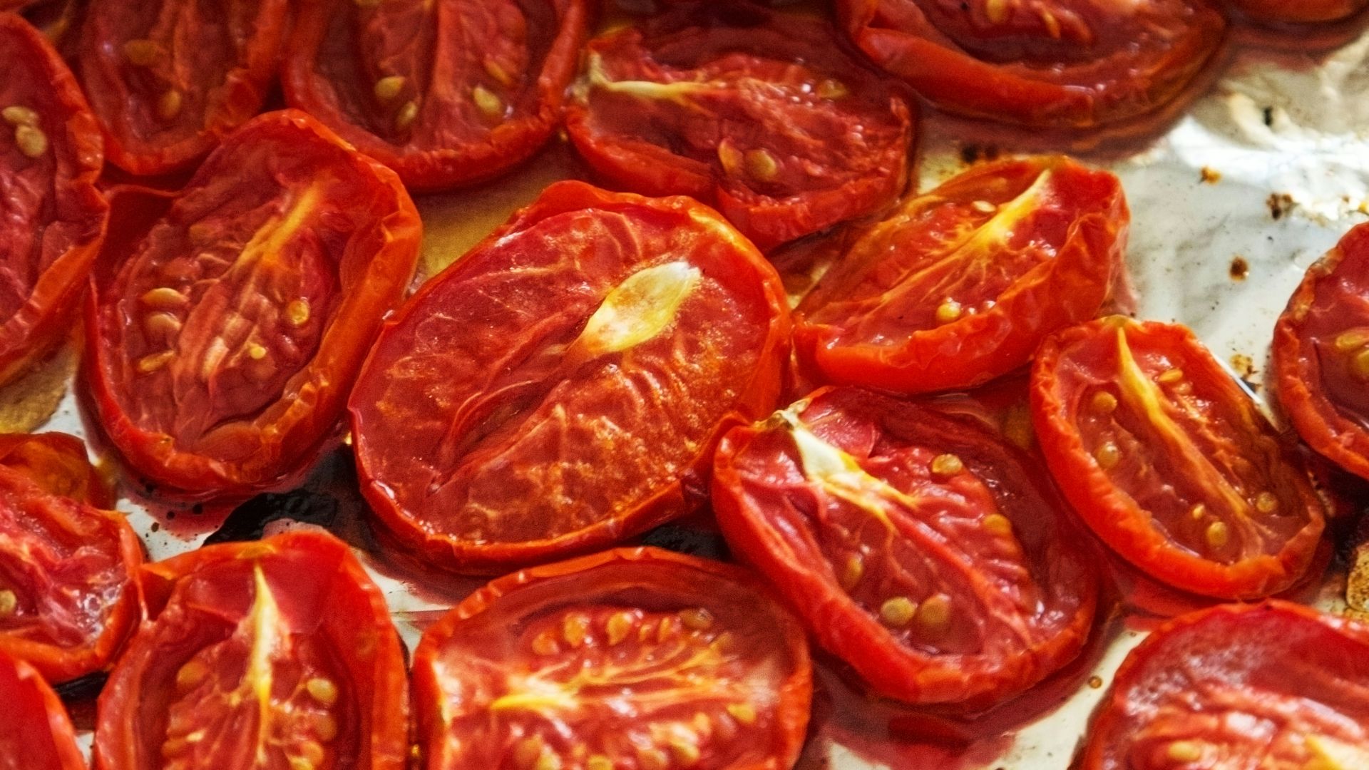 A pan filled with sliced tomatoes on top of a table