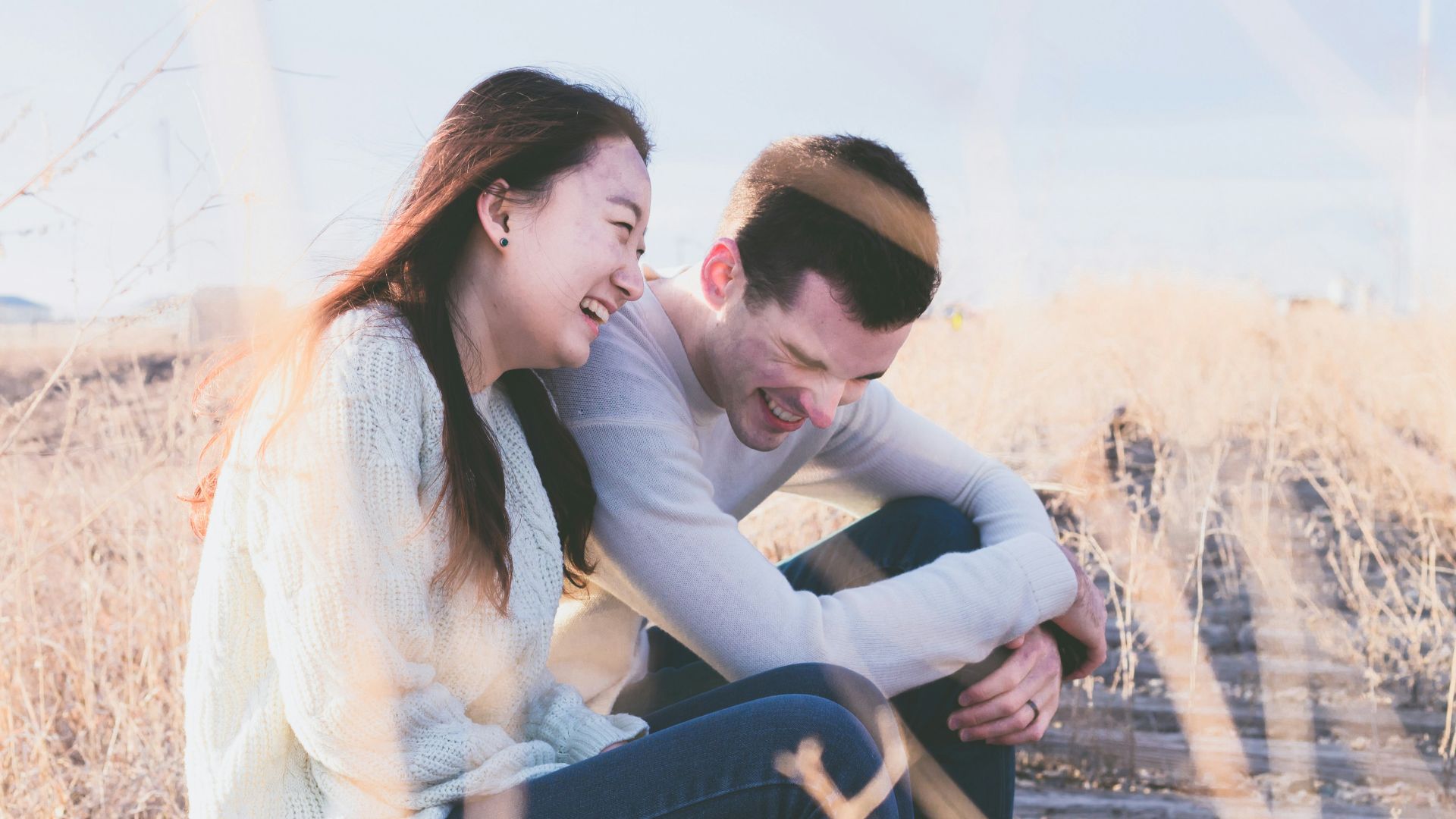photo of man and woman laughing during daytime