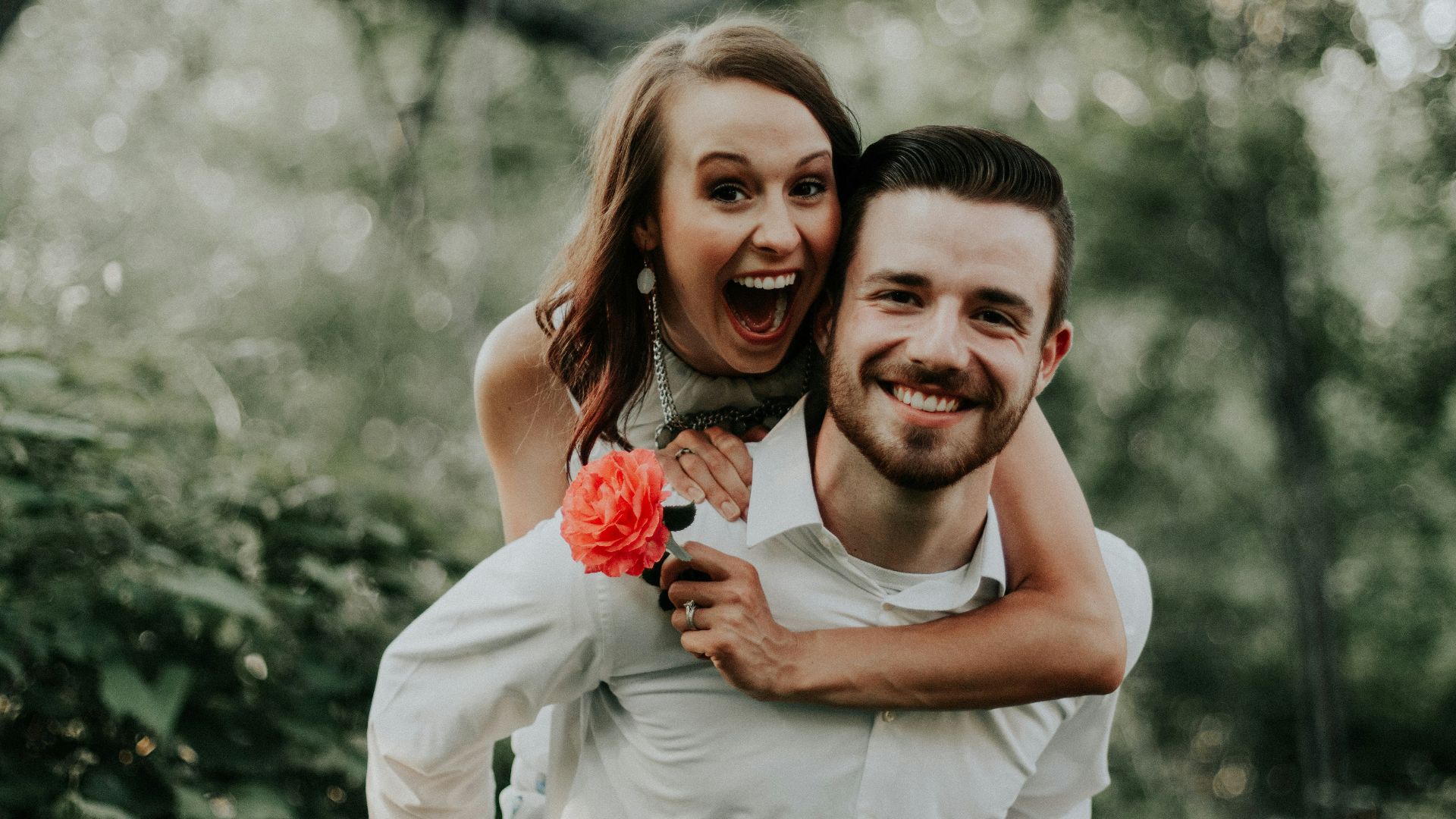 woman riding on back of man