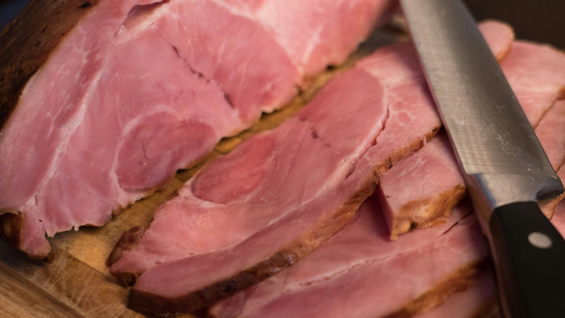 sliced meat on brown wooden chopping board